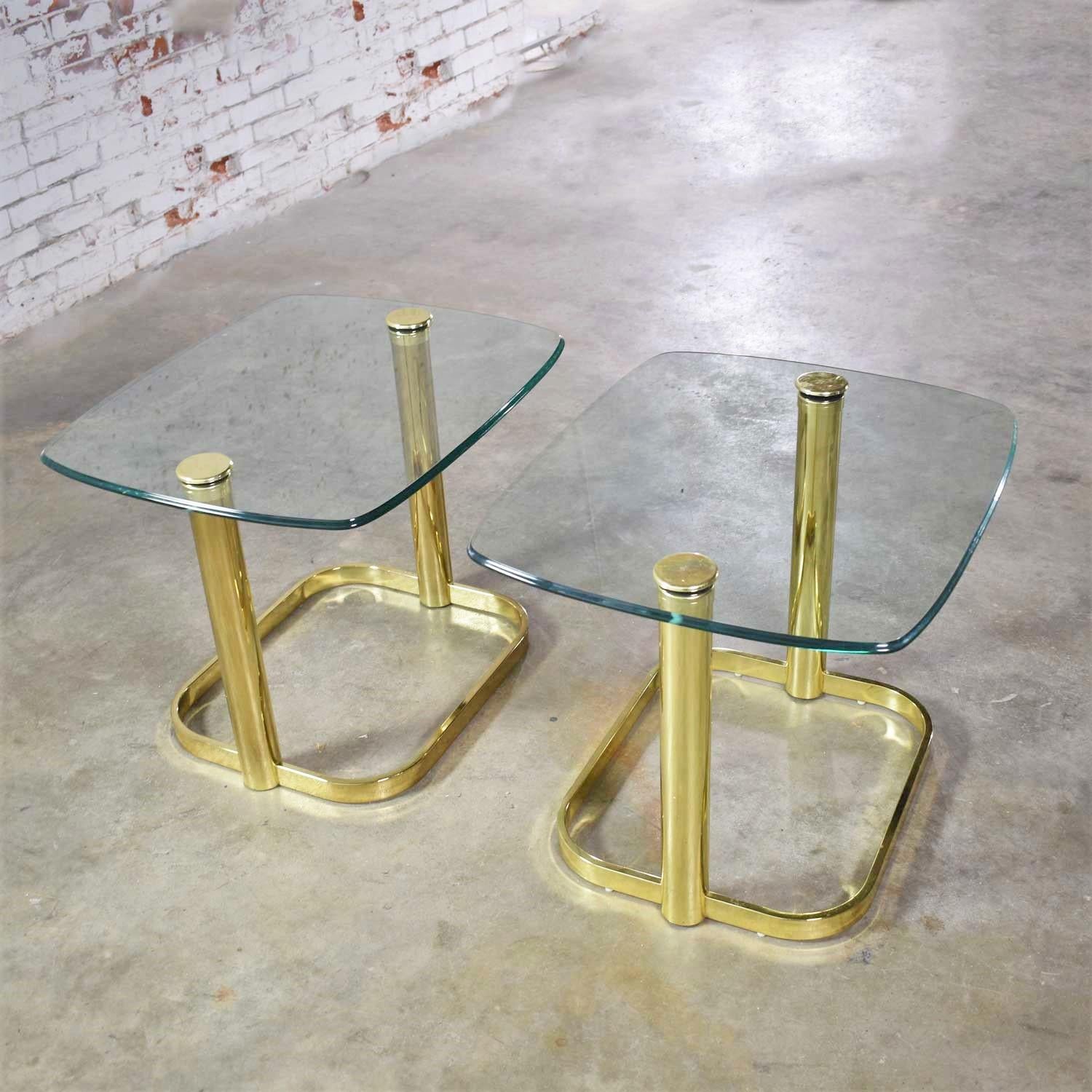 Handsome pair of modern end tables or side tables in brass plate and glass attributed to Leon Rosen for The Pace Collection. They are in wonderful vintage condition. The brass plate has the normal wear you would expect with age. The glass is great