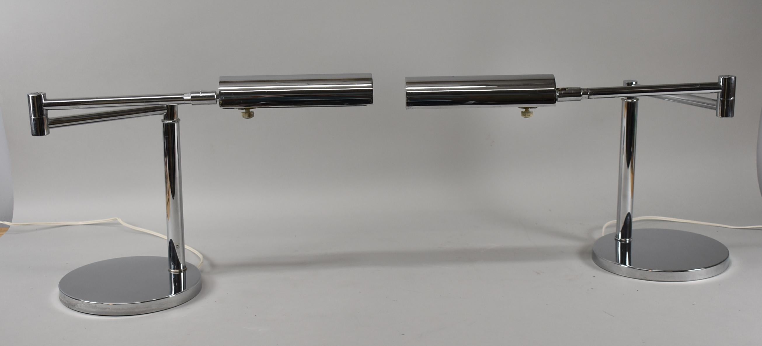 Modern pair of adjustable swing arm chrome table lamps by Koch & Lowy. Weighted heavy base.
