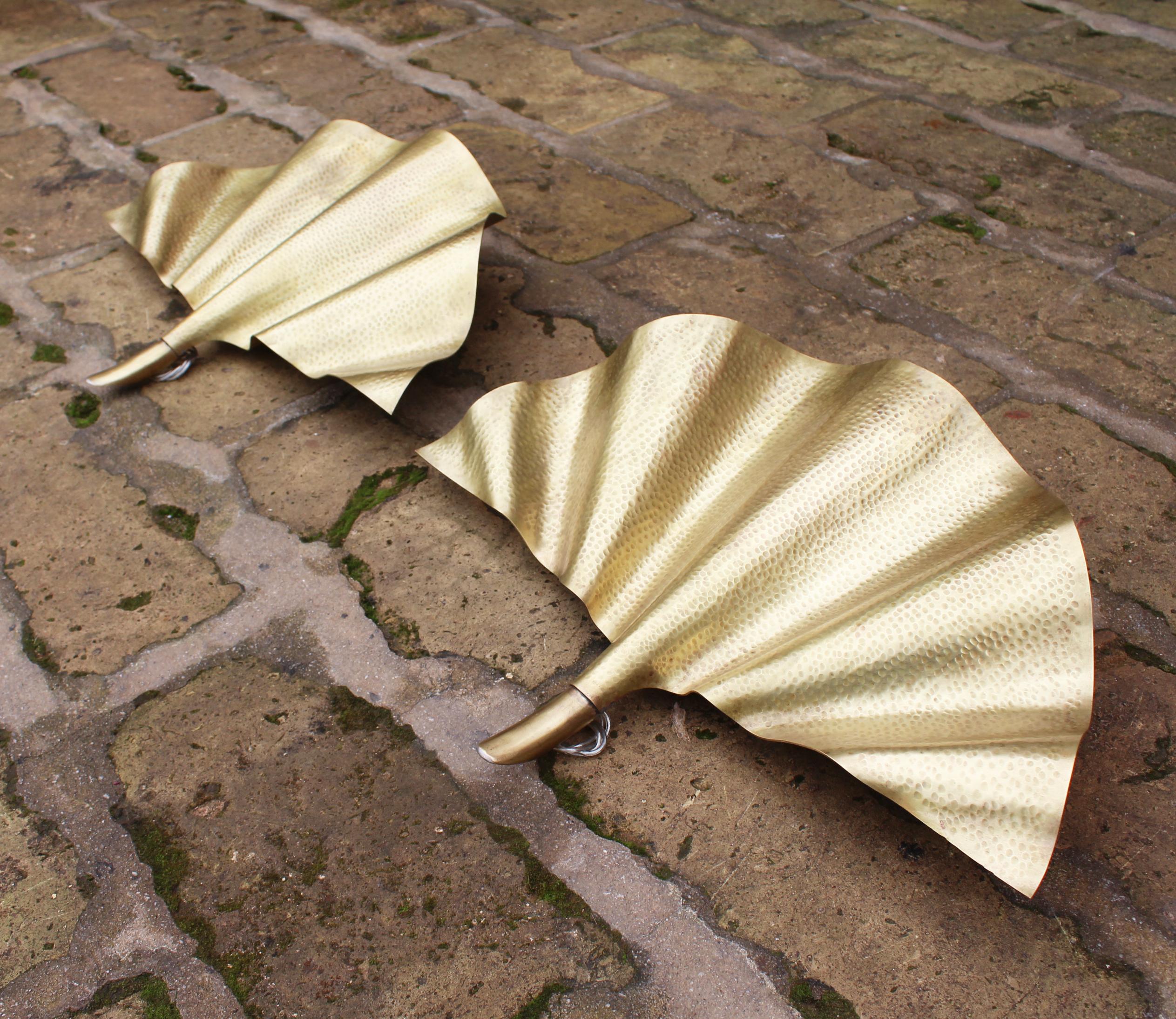 Modern pair of gilded brass leaf shaped wall lamps.