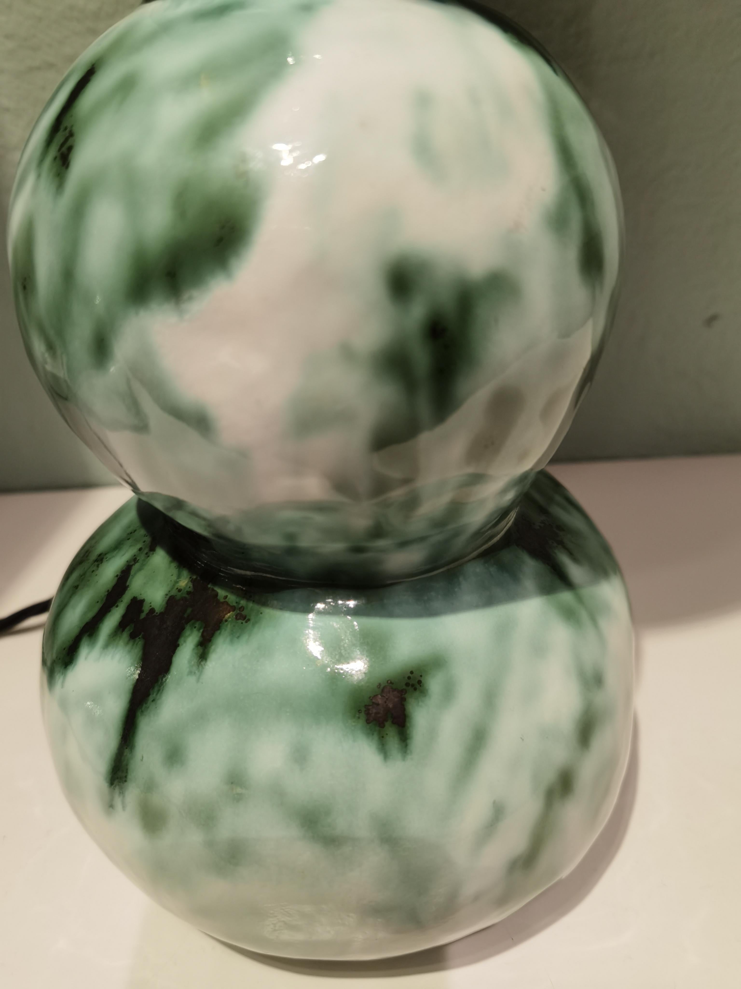 Pair of unique handcrafted table lamps in green glazed pottery. Shades in a modern strong shape made of a Pierre Frey fabric in side gold. Wired in black cotton cables. The height can be adjusted. The pottery base is slightly different in height.