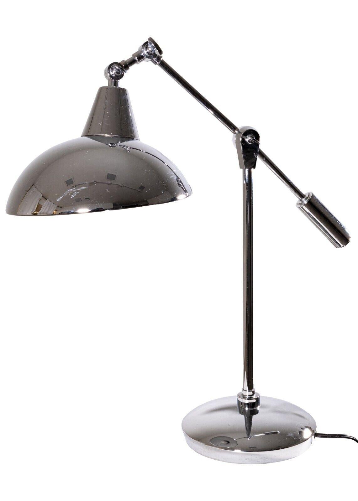 A pair of polished chrome articulating table lamps. A very sophisticated pair of lamps, perfect for a modern home. These lamps are finished head to toe in a very reflective polished chrome. The chrome is in great condition, but it does have