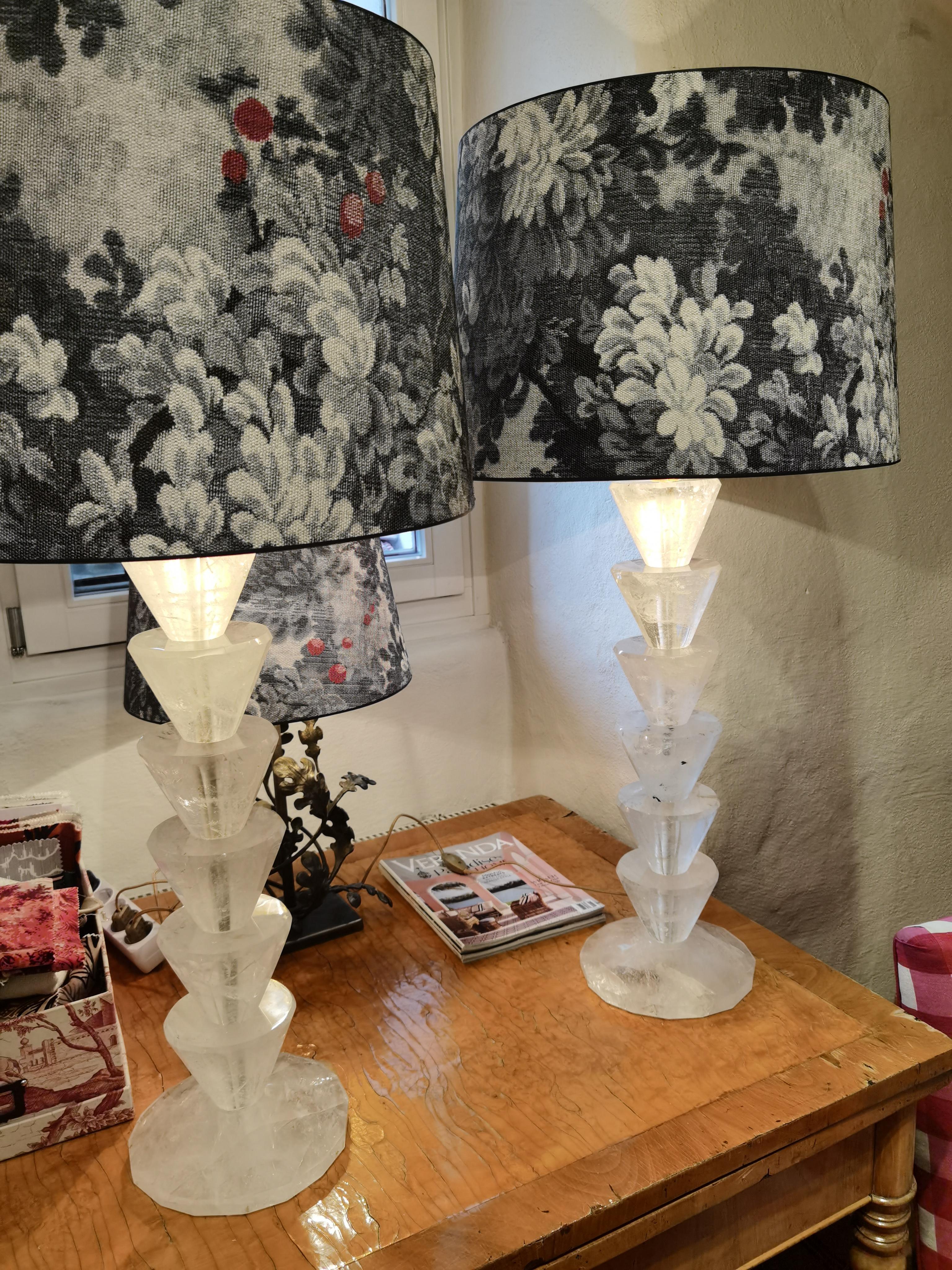 Hugh pair of French rock crystal table lamps with handmade lampshades. Each lamp is made of solid rock crystal pieces. All six rock items are facetted and carved by hand and the stand is a large round solid crystal rock.
Lamp shades handmade with