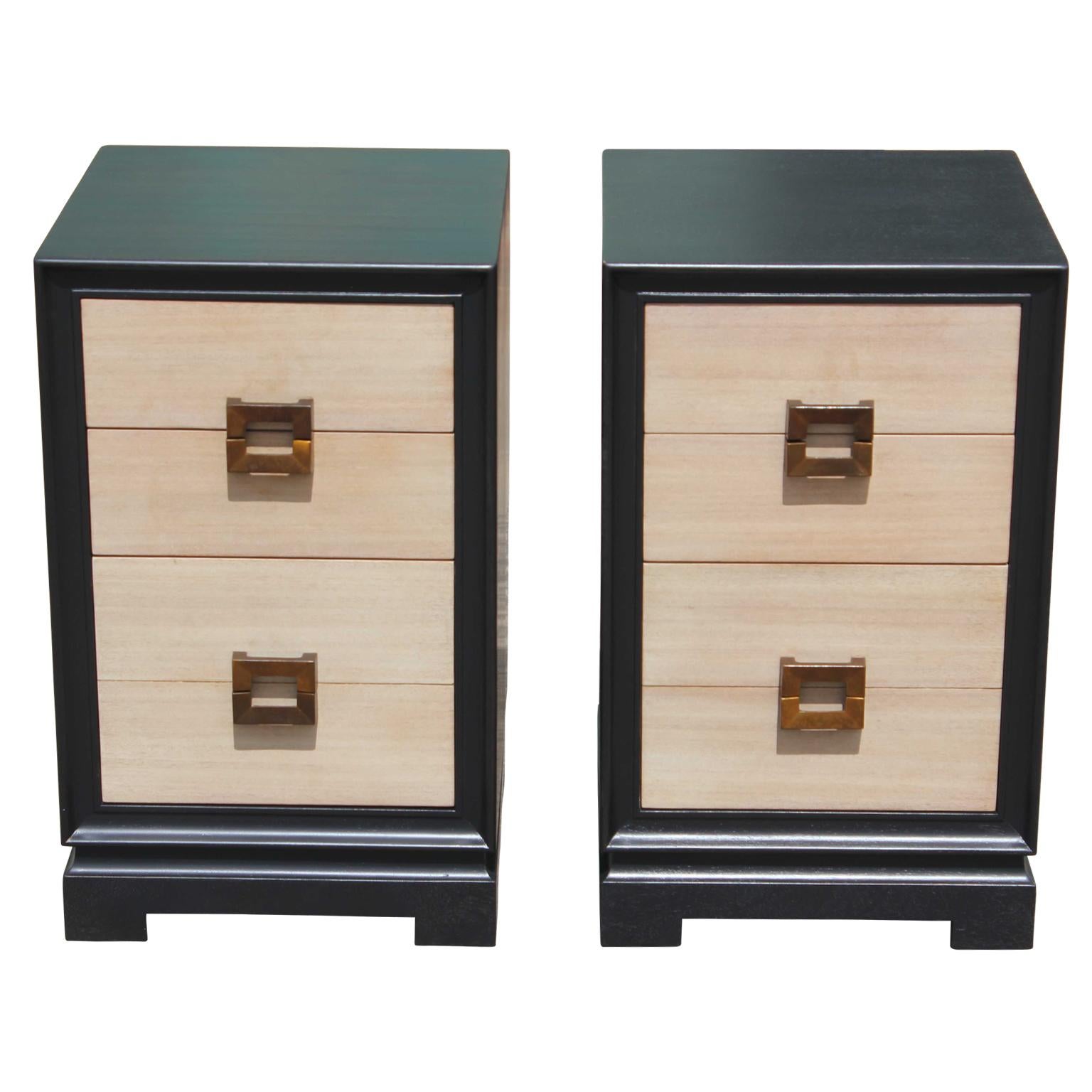 Modern pair of two-tone four-drawer nightstands with a neutral finish on the front of the drawers and with brass pulls. In the style of Grosfeld House or Baker Furniture.