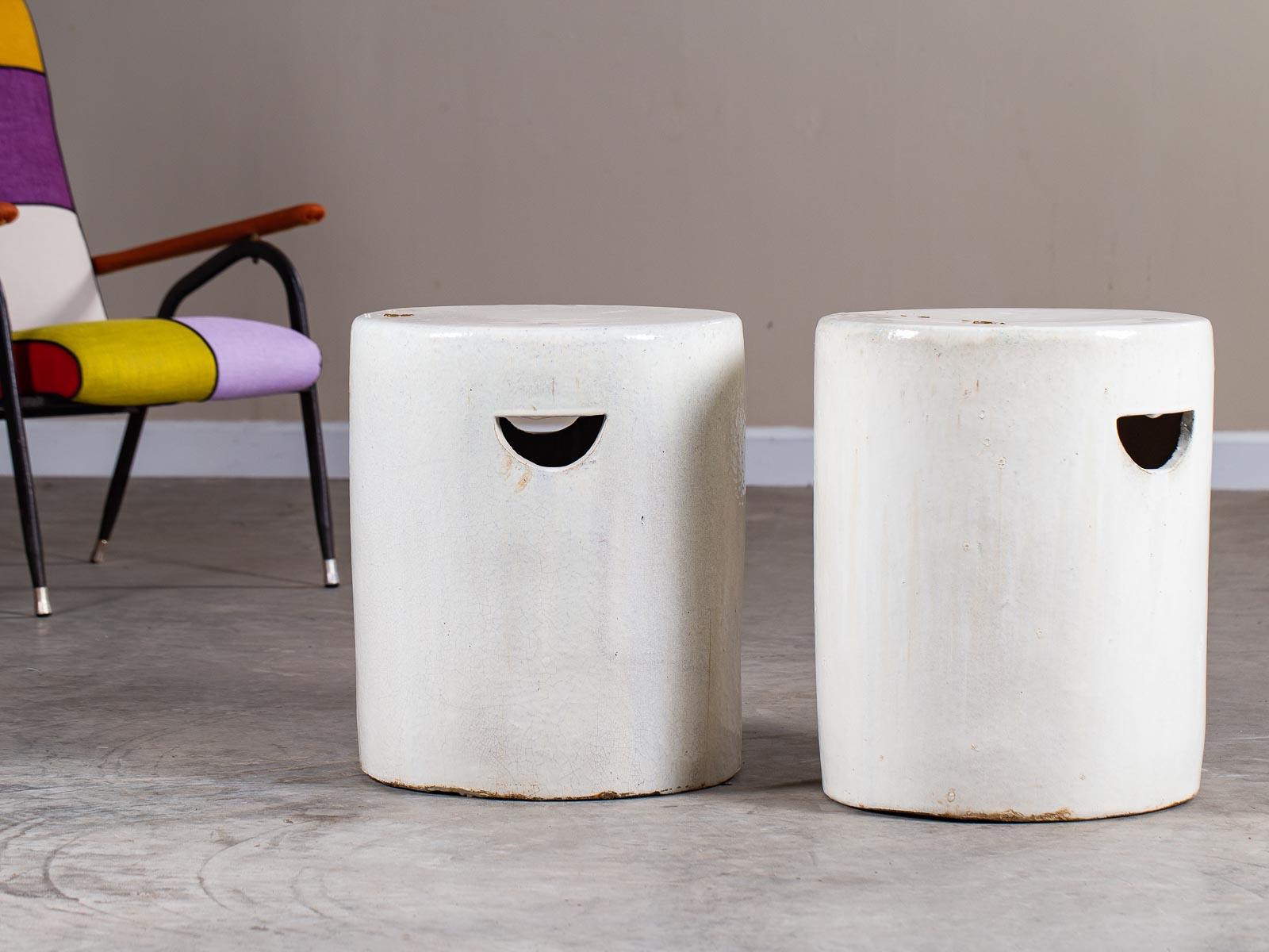This pair of modern handmade ceramic garden seats or stools each have a handsome contemporary profile with straight cylindrical sides and a circular top. Crafted completely by hand each garden seat stool bears the mark of individual creation. Please