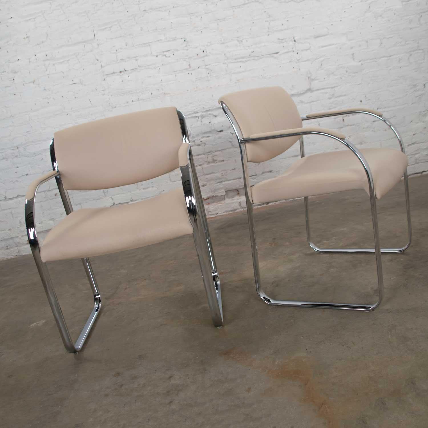 Handsome pair of modern chrome accent or dining armchairs with an off-white gaberdine-like fabric upholstery. They are in wonderful original condition. The chrome has been cleaned and polished and is gleaming. The fabric is in awesome condition. The