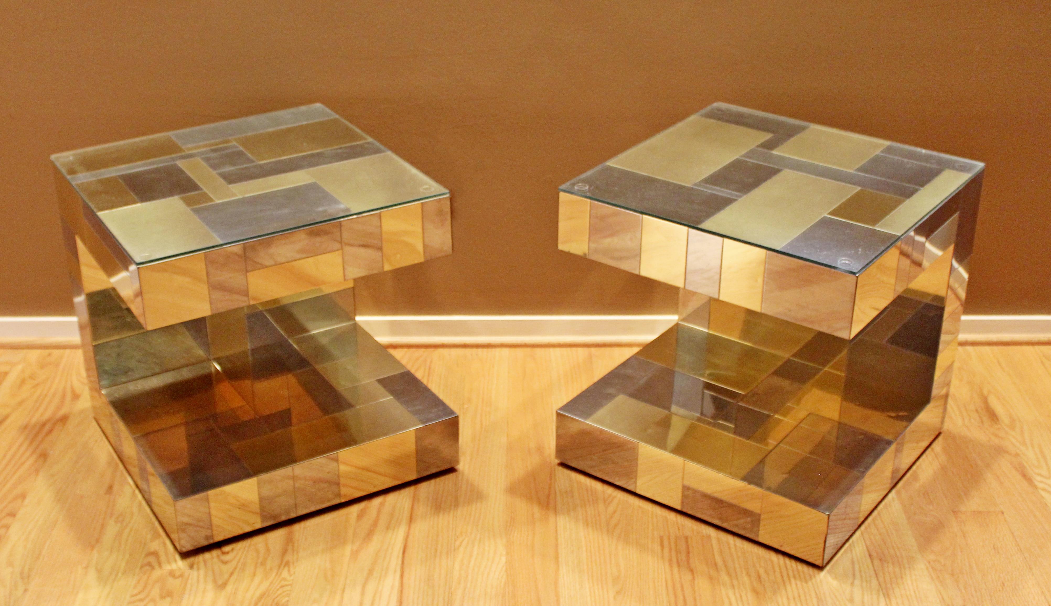 For your consideration is a wonderful pair of nightstands or side tables, made of patchwork brass and chrome and with glass tops, signed by Paul Evans for Directional, the Cityscape collection, circa 1970s. In good vintage condition. The dimensions