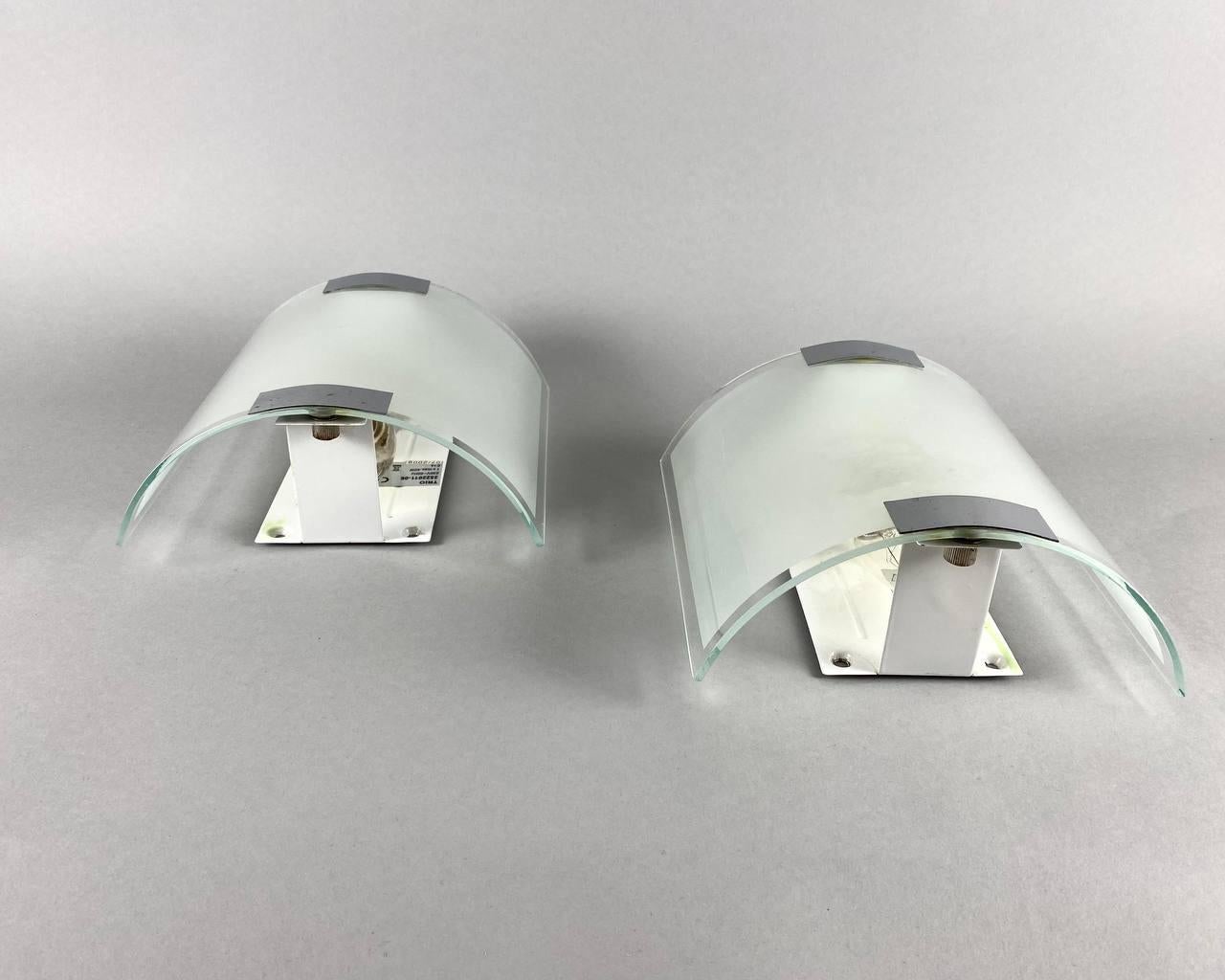 Paired wall lamps from Trio Lighting, Germany, 2009. 

Pair of sconces are made of high quality glass with metal elements.

 Stylish wall lamps will fit into any interior of the house and will be an excellent room decor in any apartment. 

It