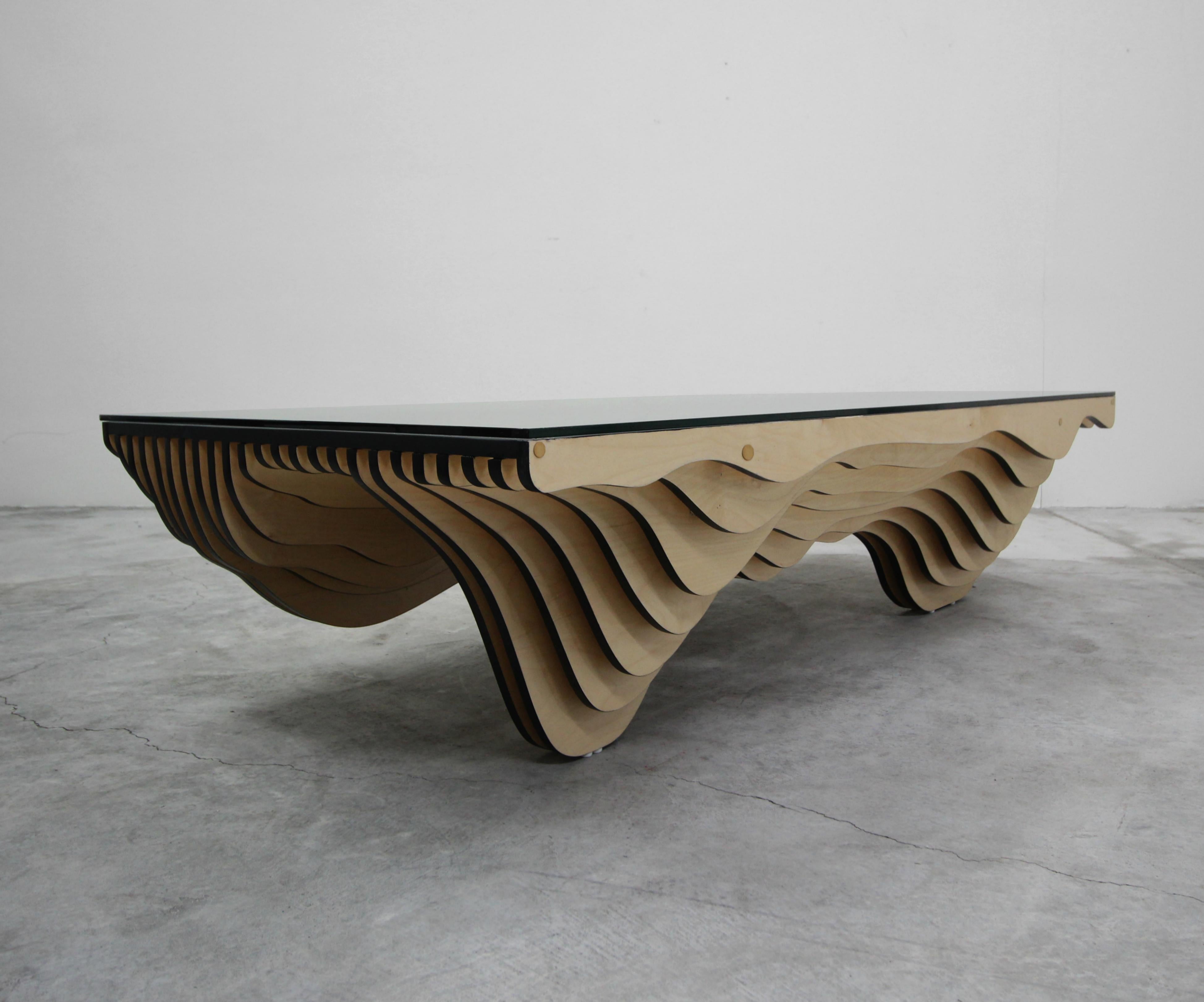 There are no words. This very large coffee table is a one of a kind, design masterpiece. With intriguing vertically stacked wood details making it a real unique, eclectic piece. The table has an appearance of waves or dunes. It is very heavy, and