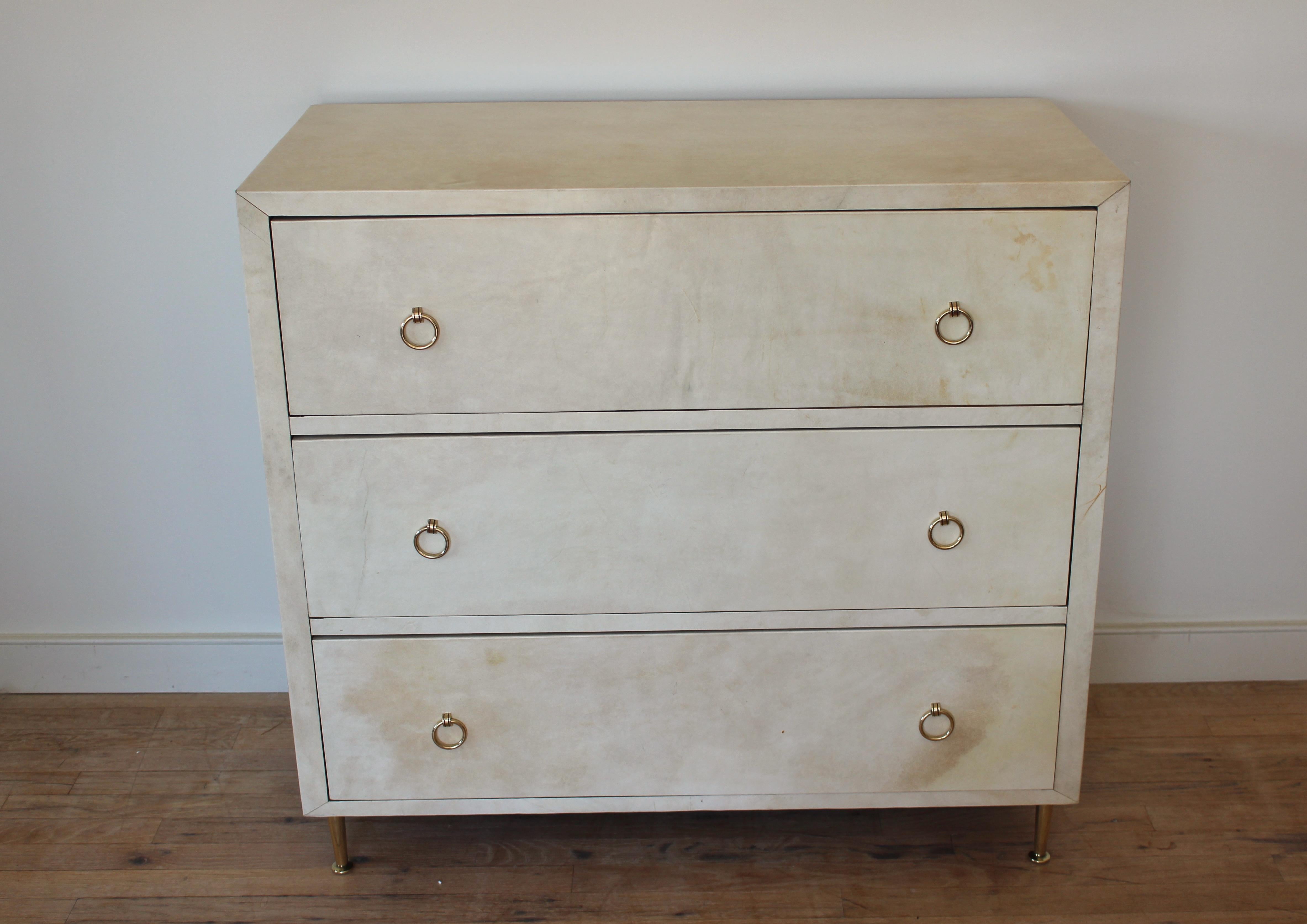 Modern parchment dresser with brass ring pulls and feet.... In the manner of Samuel Marx.