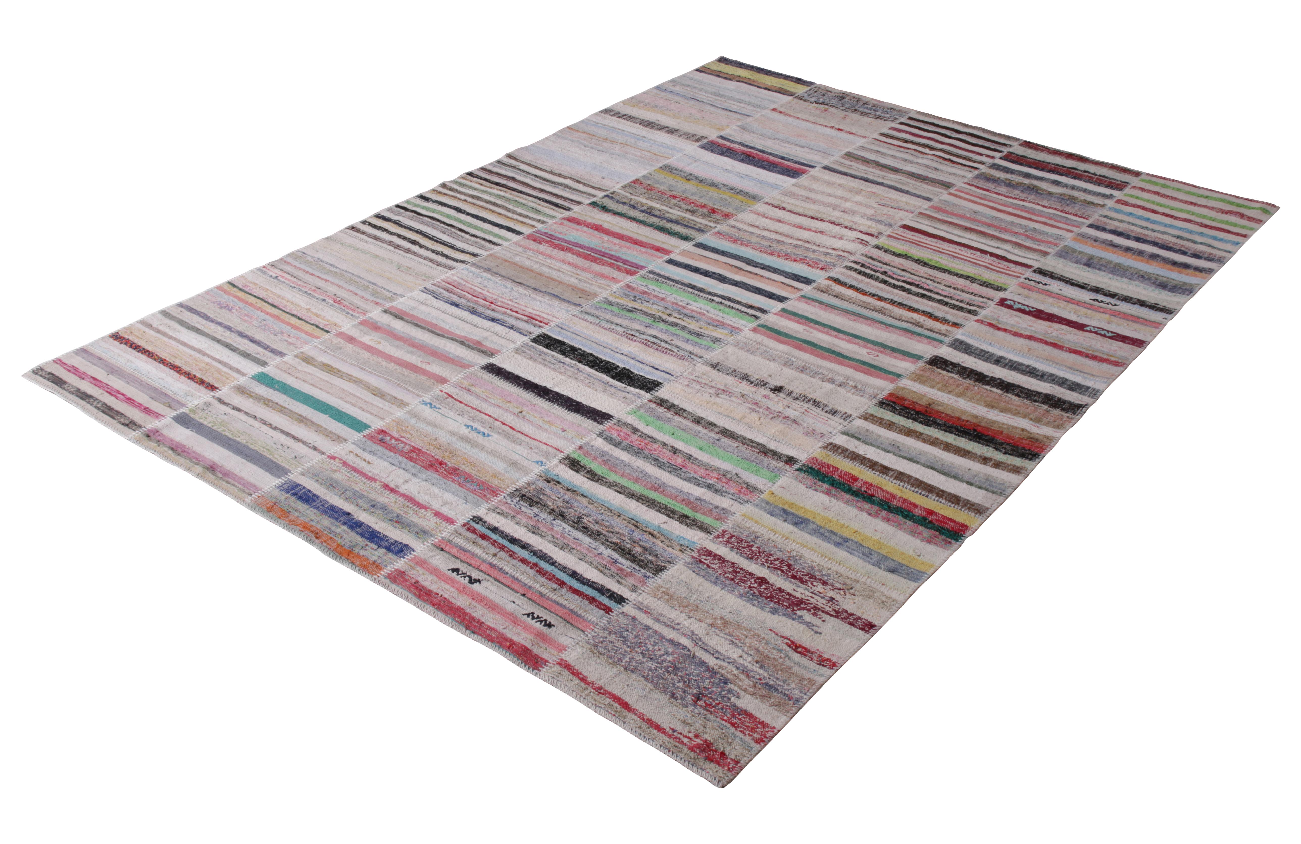 Handwoven in a wool flat-weave utilizing vintage yarns, this modern Kilim rug from Rug & Kilim’s Patchwork Kilim rug collection marries inspiration from midcentury flat-weave rugs with a whimsical spectrum of red, blue, pink, green, and other