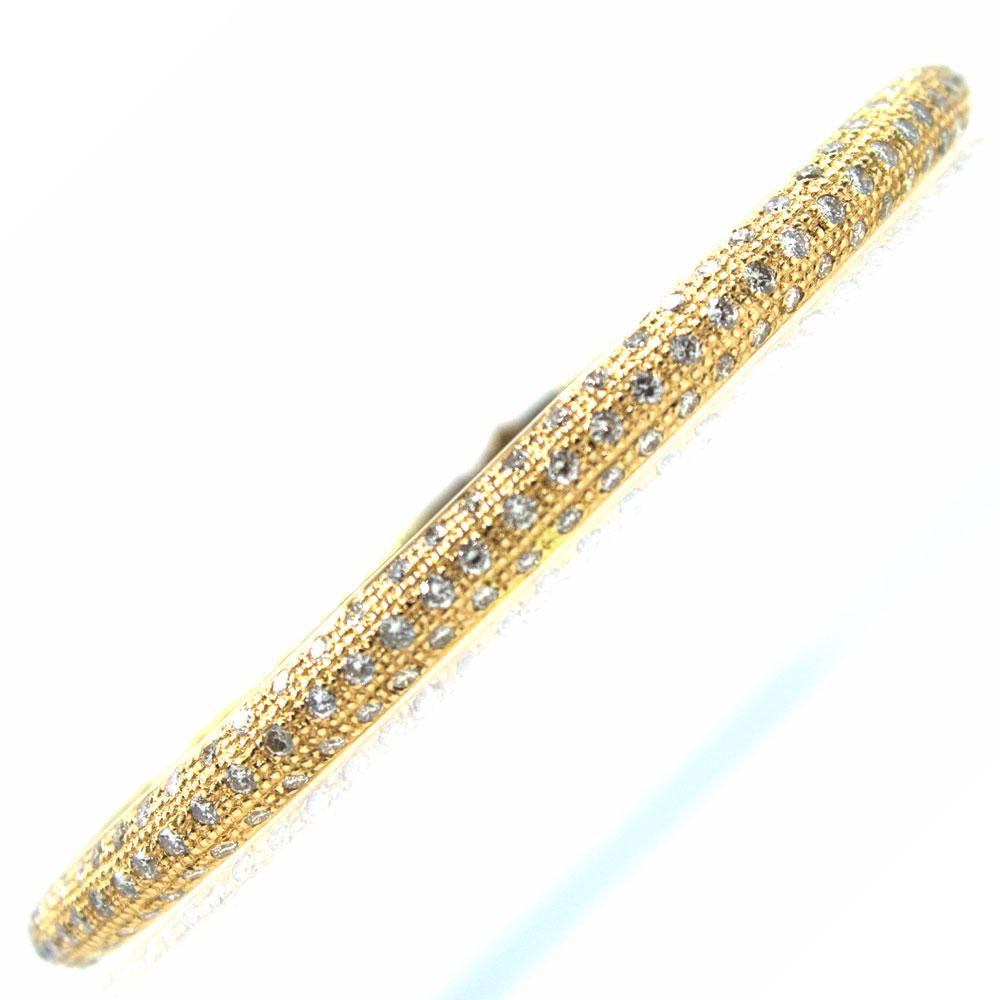 This modern pave diamond bangle bracelet is fashioned in 18 karat rose gold. The bangle features 99 round brilliant cut diamonds that equal approximately 3.00 carat total weight. The diamonds are H-I color and SI clarity. The bracelet is a larger