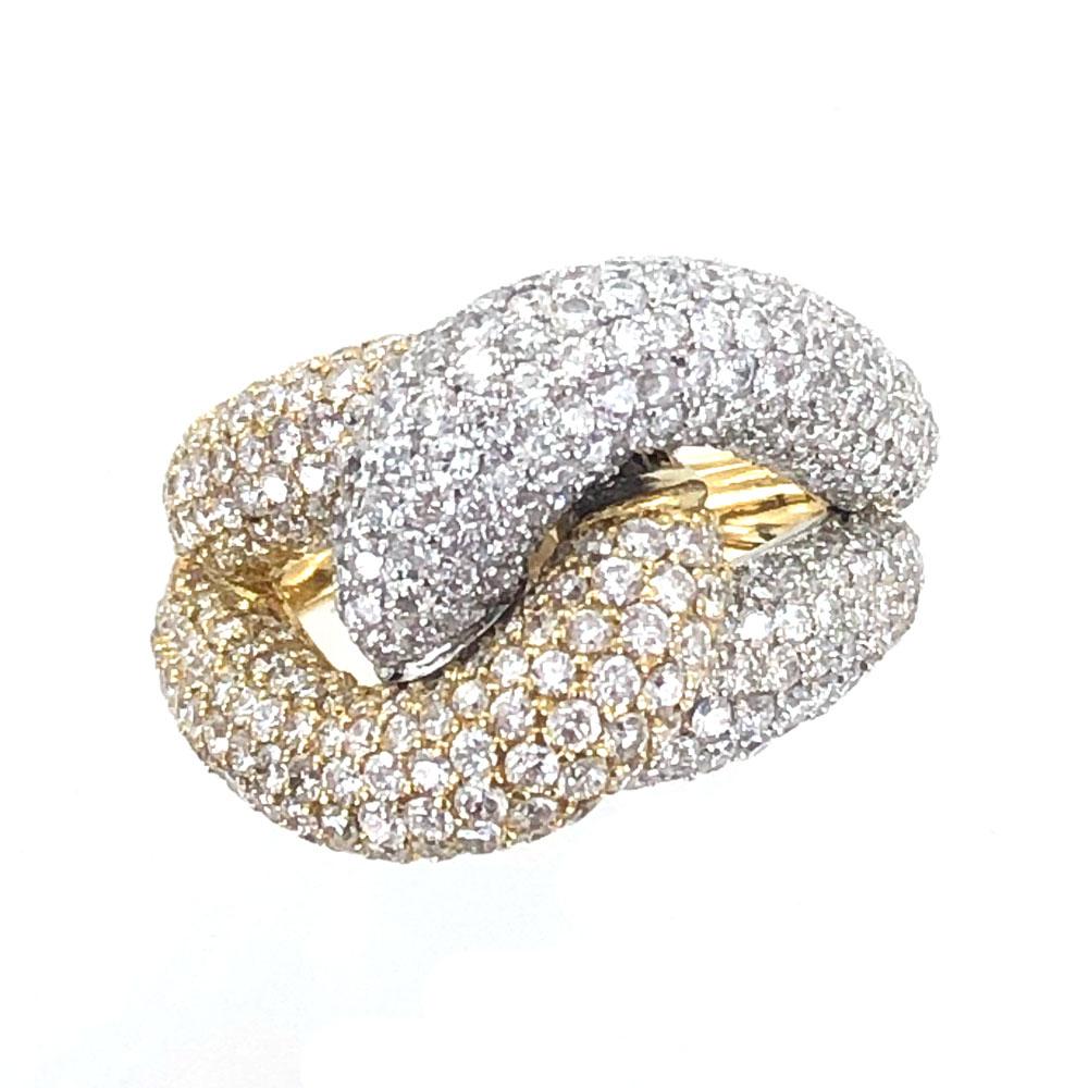 Fabulous pave diamond knot ring fashioned in 18 karat yellow and white gold. The ring features 456 round brilliant cut diamonds weighing approximately 4.50 carats. The diamonds are G-H color and VS-SI1 clarity. The ring measures 16mm in width and
