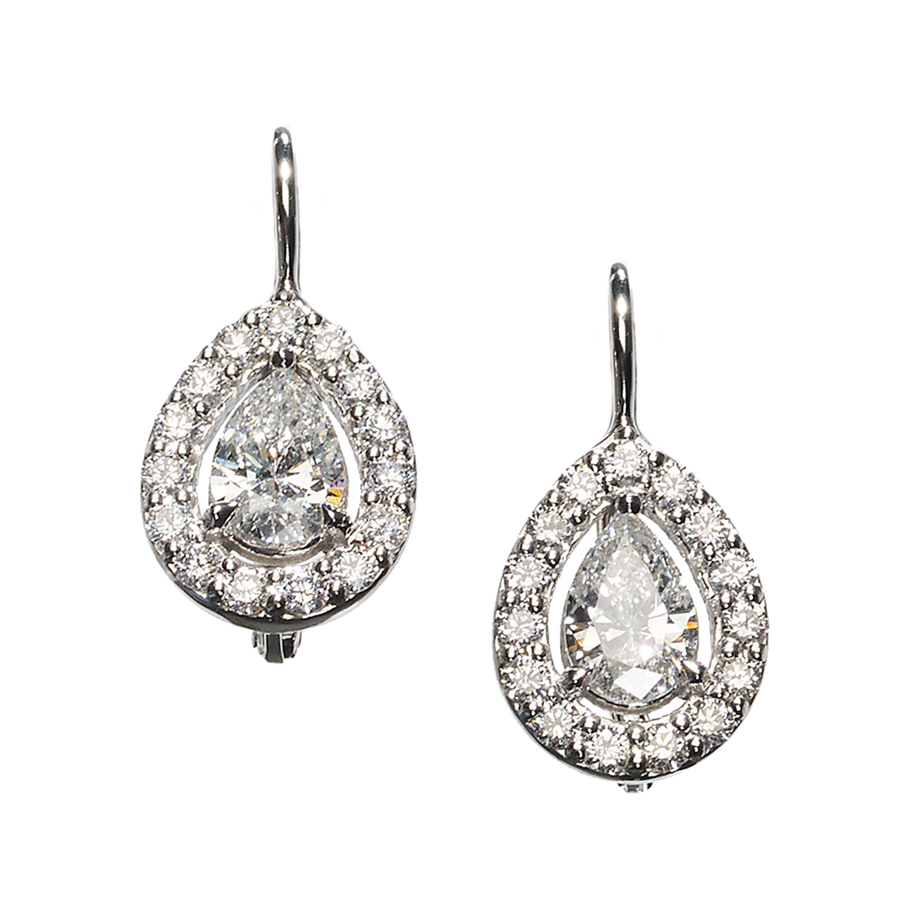 A pair of modern pear shape diamond and white gold cluster earrings, with pear shape diamonds in openwork, round brilliant-cut diamond, micro pavé set cluster surrounds, mounted in 18ct white gold, on wires, with safety fittings. 