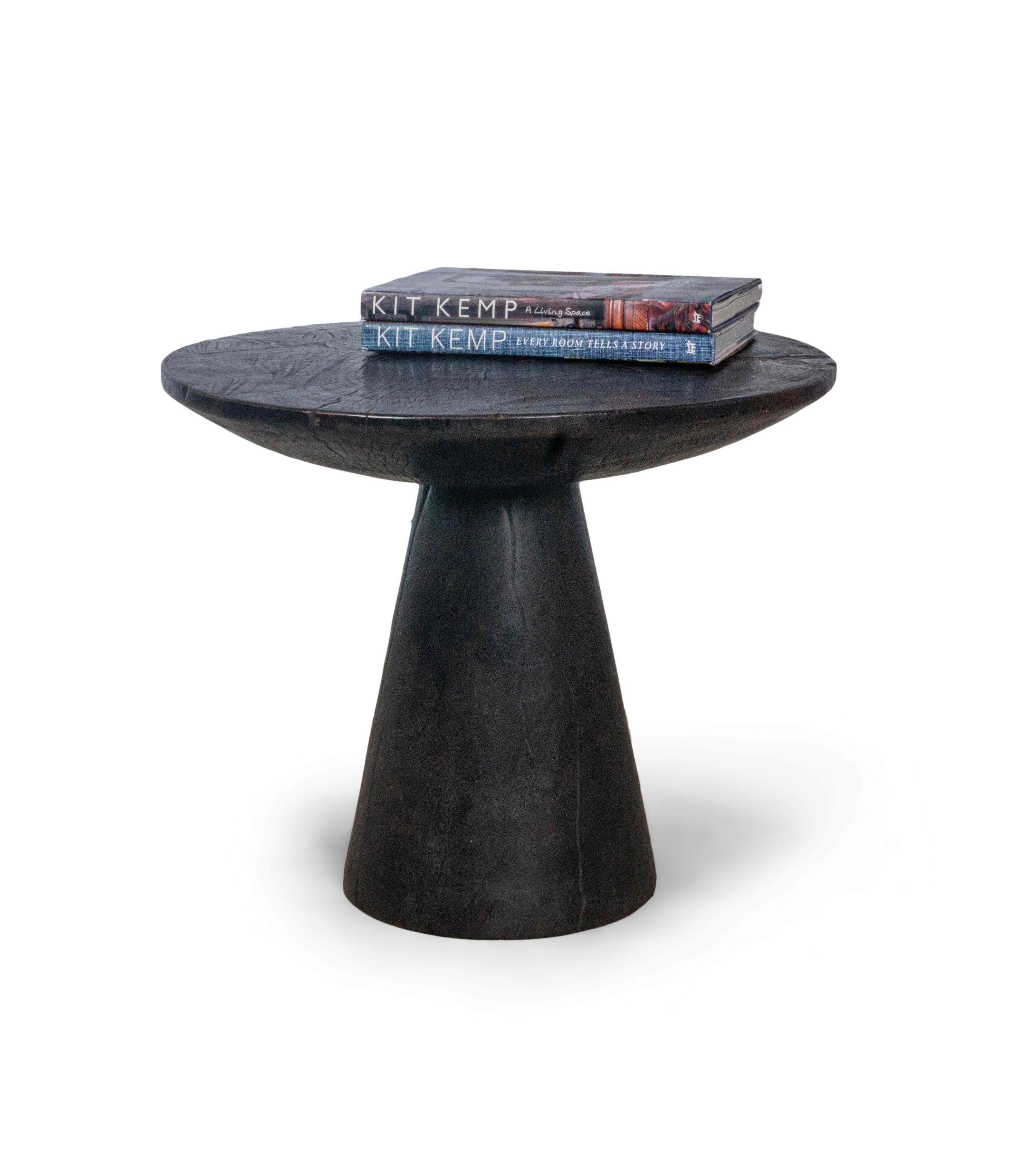 This modern pedestal side table features a unique pedestal design. This piece is carefully crafted by marrying pieces of end cut elm to create a top with a one of a kind texture and features a solid tapered base. This beautiful design adds