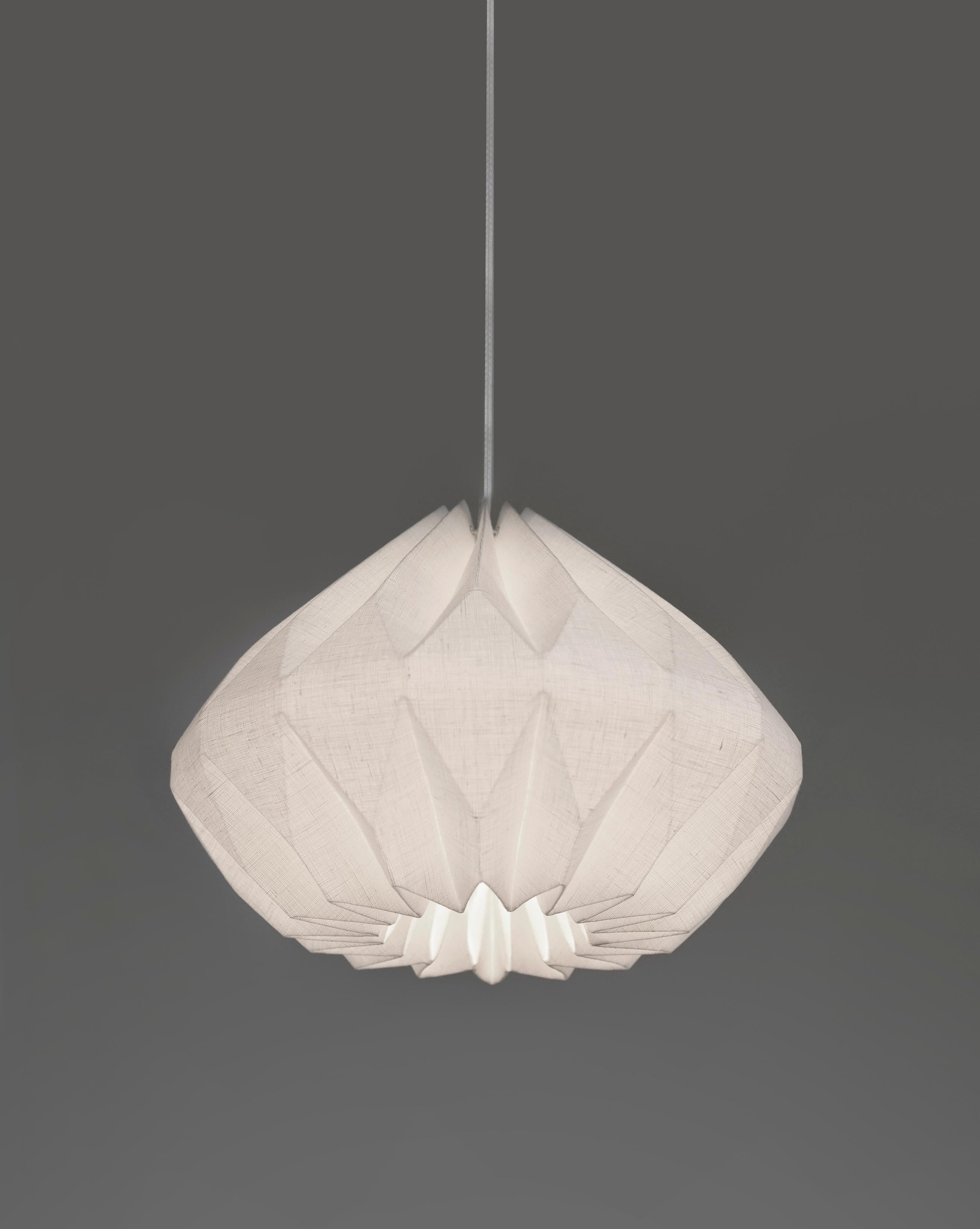 This Mid-Century Modern-style pendant light will add an interesting and functional work of art to your interior. Made of laminated linen fabric,  this hand-folded pendant lamp diffuses the light providing soft ambient lighting capable of