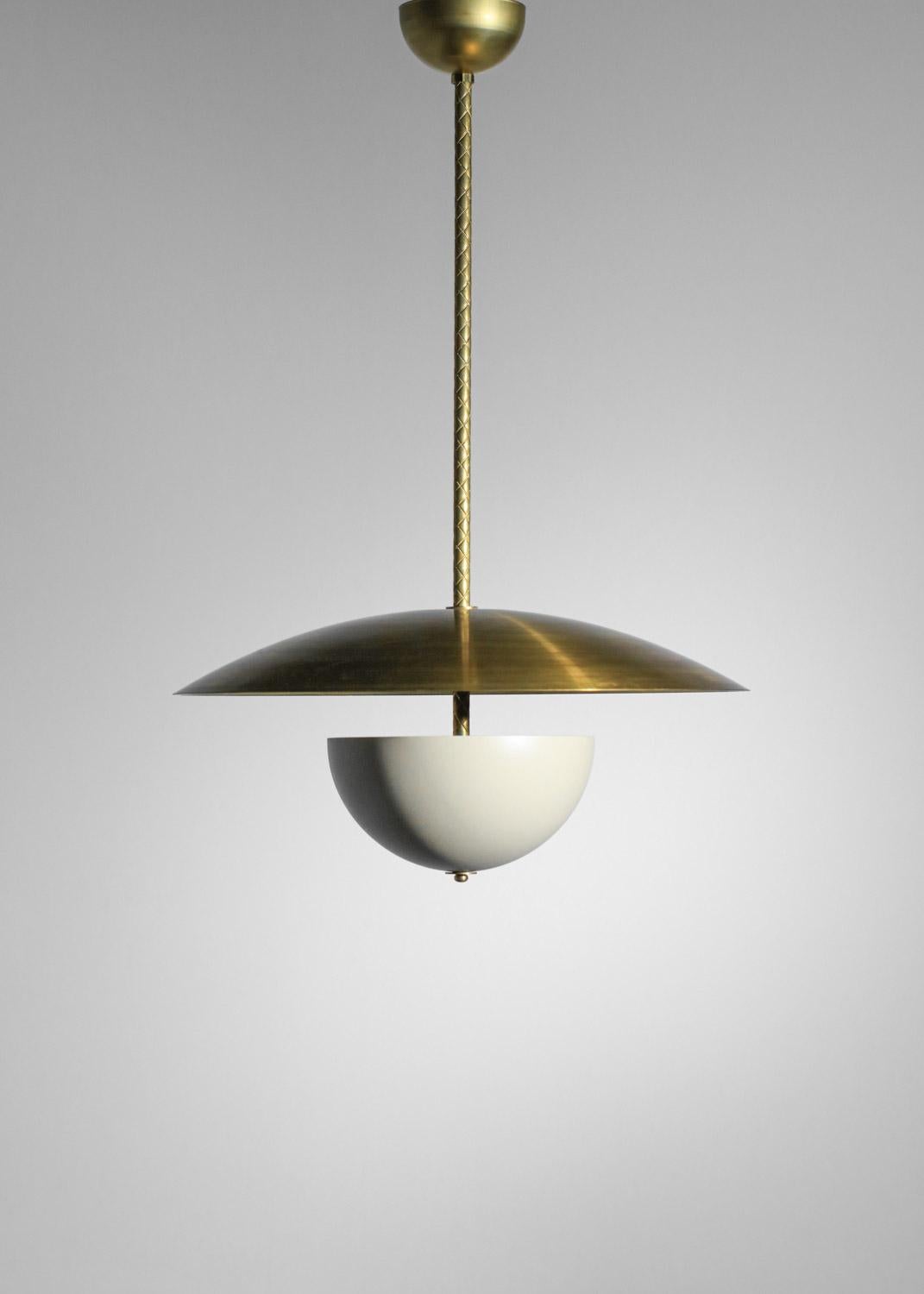 This chandelier is composed of a solid brass dome, a large beige lacquered central shade and a fixing bar with a patinated solid brass bell. We recommend three E14 LED bulbs for this fixture. Realization of the order.