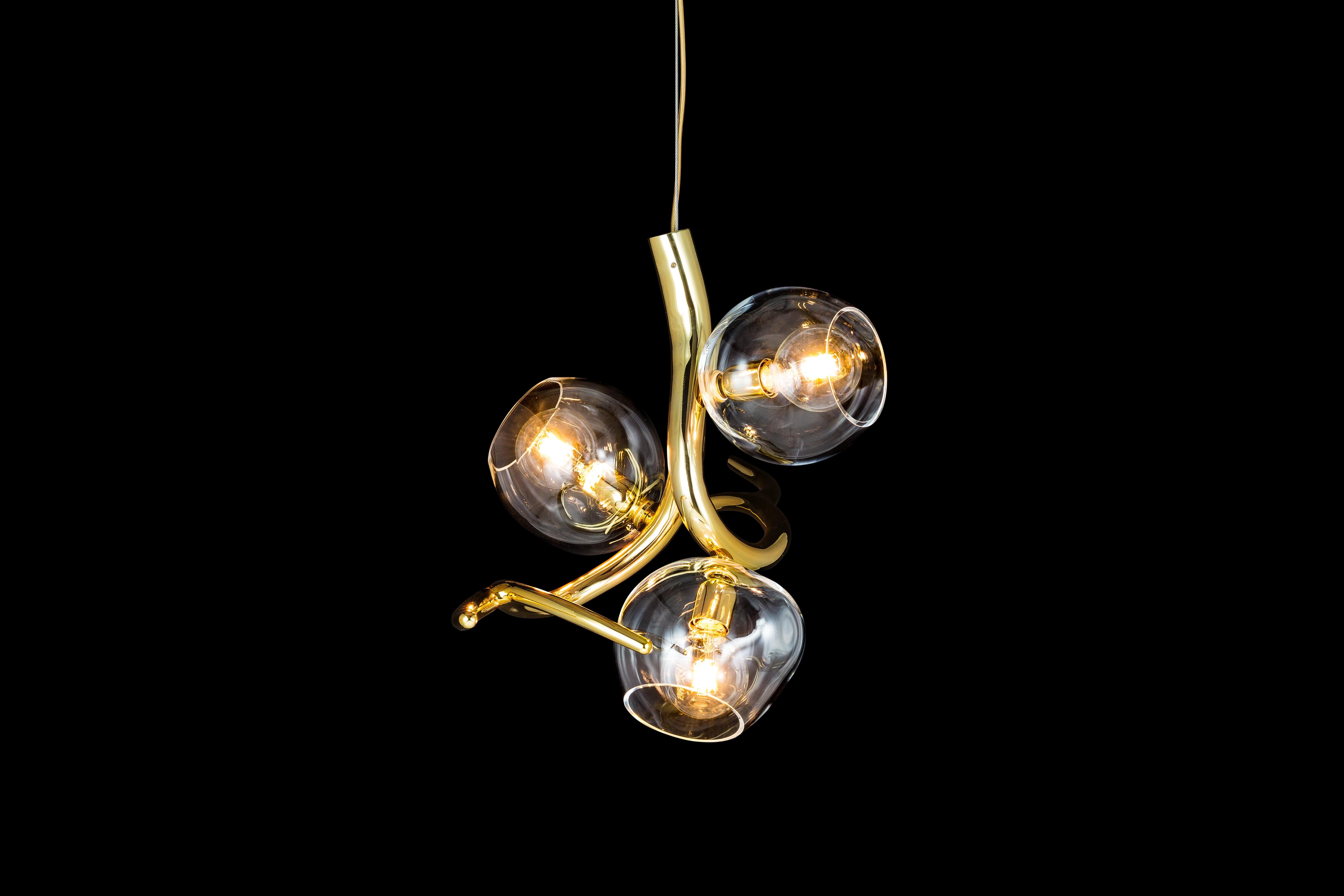 Named after the ancient Greek Goddess of dew, this Ersa modern pendant in a brass burnished finish with iridescent glass spheres offers light with a sculptural touch for every possible position or space. The Ersa pendant is available with one, two