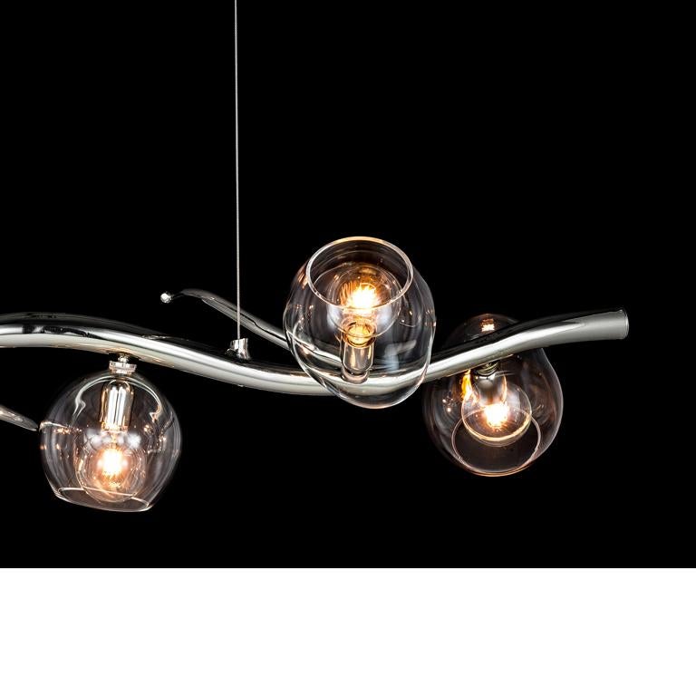 The Ersa, a modern pendant in a nickel finish with glass spheres, is designed by William Brand, founder of Brand van Egmond. Full of character and created to bring light above a table or bar, this Ersa is available in different finishes for the