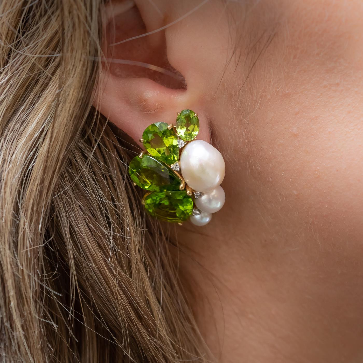 A pair of peridot, pearl and diamond earrings, set with eight graduating pear shaped peridots, with a total weight of 39.75ct, six cultured and baroque pearls, with a total weight of 34.55ct and eight, round brilliant-cut diamonds, with a total