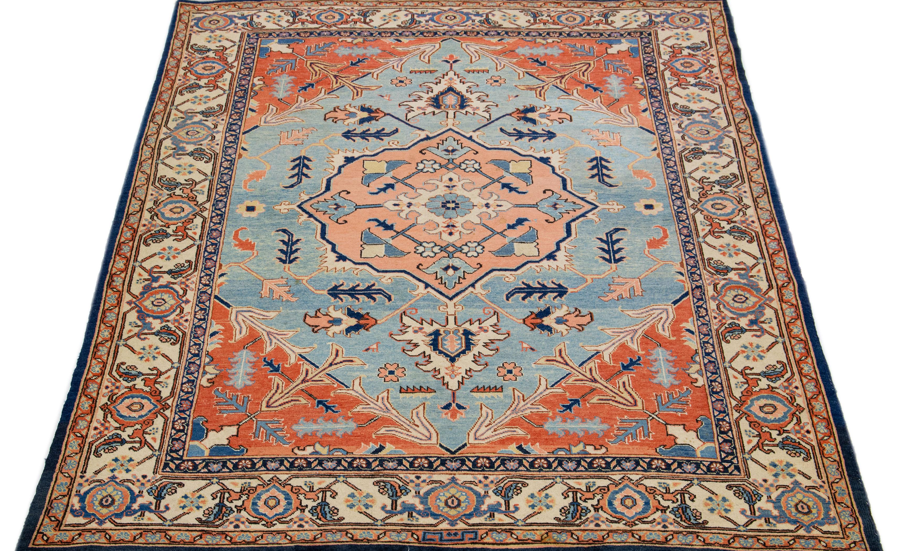 Beautiful Modern Heriz hand-knotted wool rug with a blue and rusted field. This Persian rug has a beige frame and accents in a gorgeous all-over layout geometric medallion floral motif.

This rug measures: 6'5