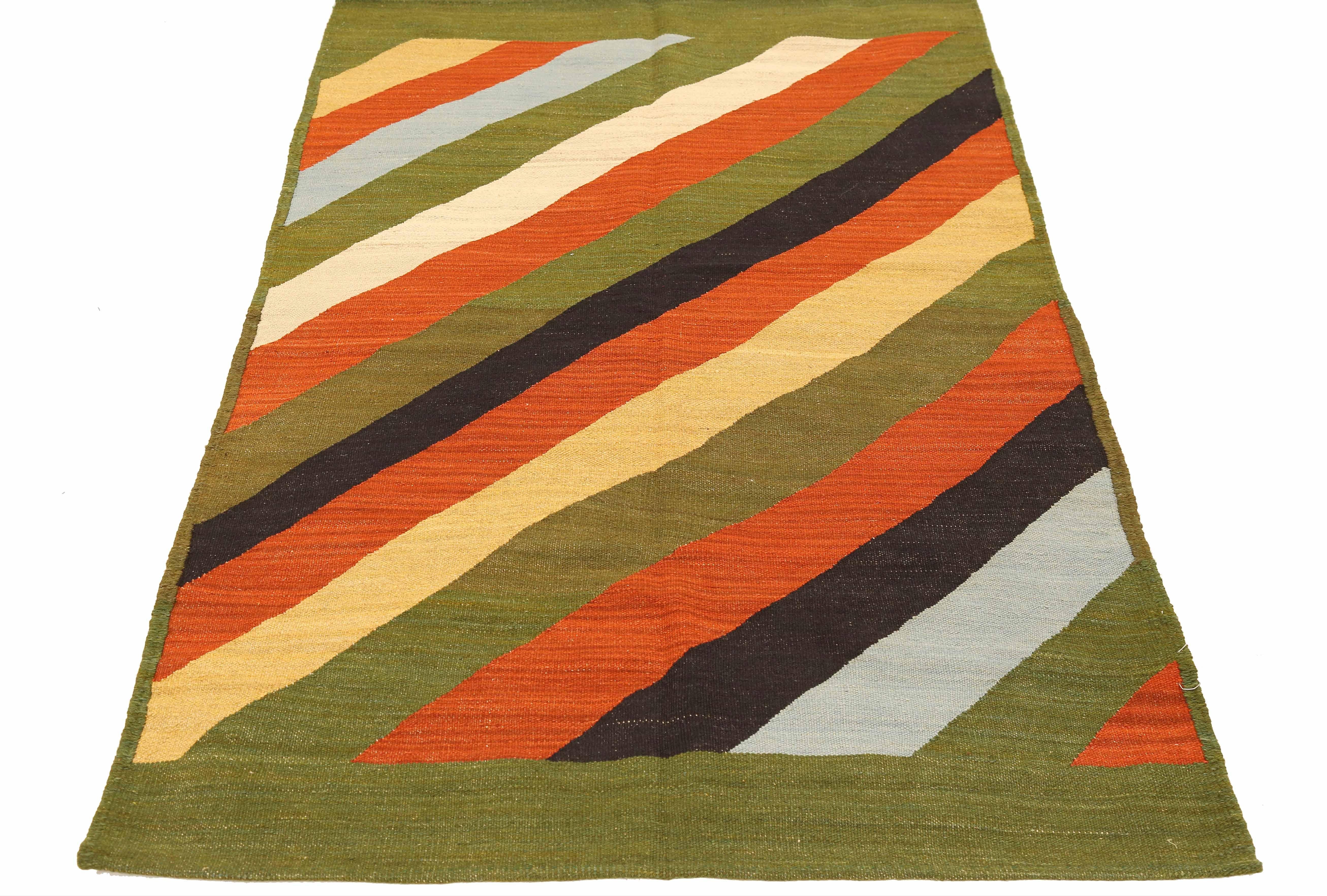 Modern Persian rug handwoven from the finest sheep’s wool and colored with all-natural vegetable dyes that are safe for humans and pets. It’s a traditional Kilim flat-weave design featuring diagonal colored stripes on a green field. It’s a stunning
