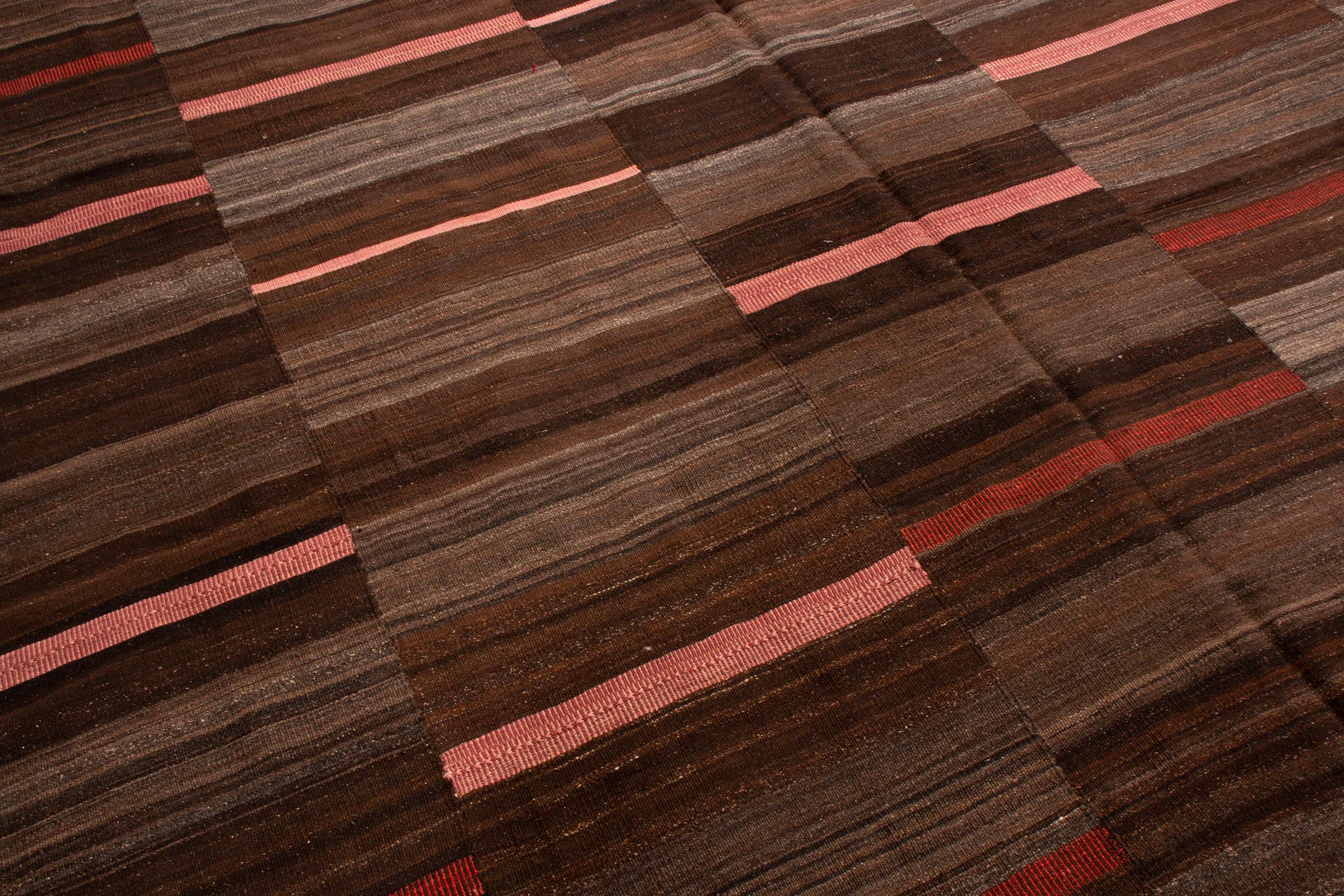Originating from Pakistan in the 1950s, this vintage transitional wool kilim is of a unique family woven in vertical panels, each of the five with their own variation of an eccentric geometric design. Flat woven in high quality wool with distinct,