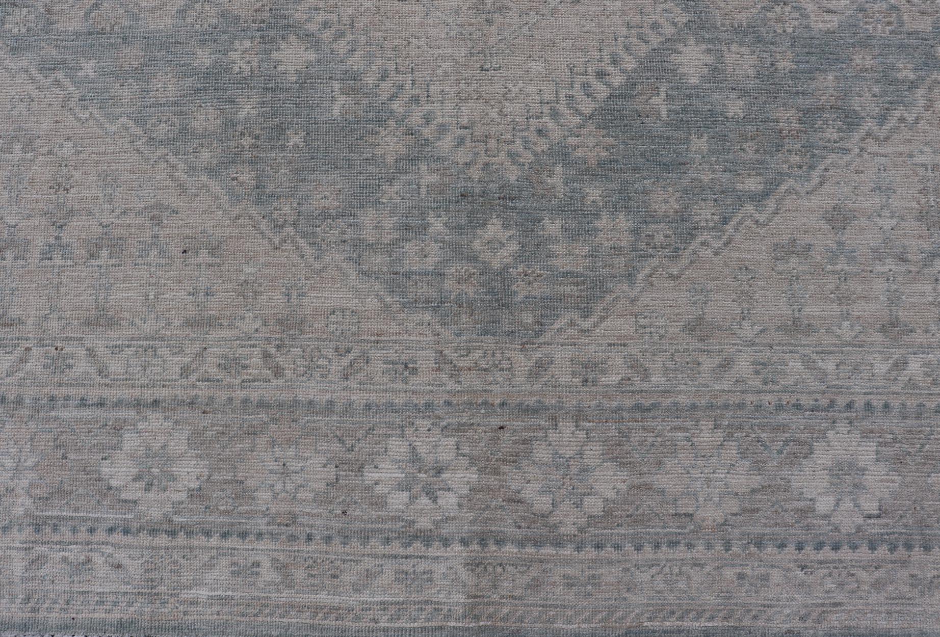 Modern Persian Shiraz Rug with Tribal Design in Light Blue Background and Taupe. Keivan Woven Arts/ rug AWR-8003 Country of Origin: Afghanistan Type: Shiraz Design: Floral, Medallion Abstract-Tribal 

Measures: 8' x 9'9

This Shiraz presents