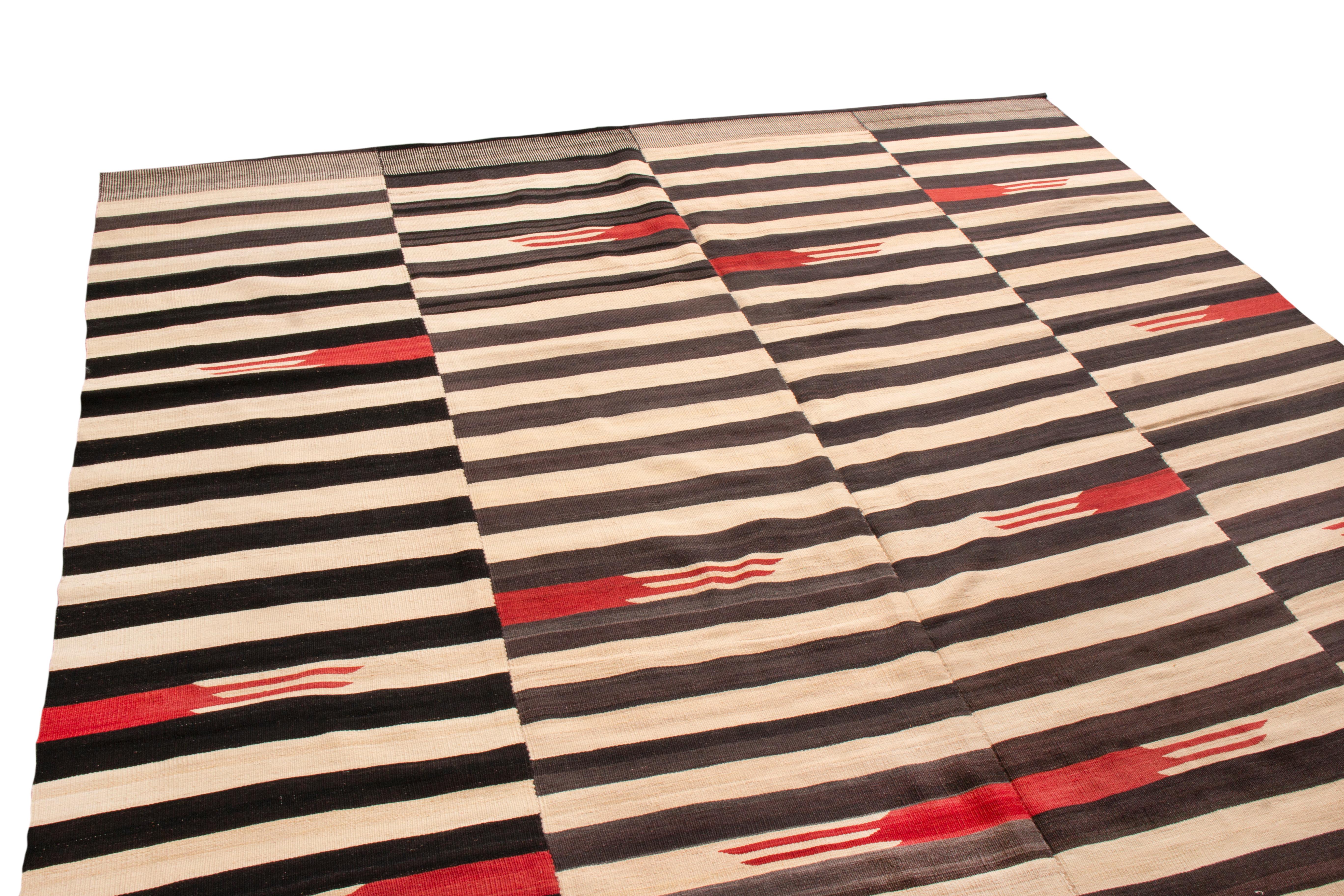 Originating from Persian, this modern transitional wool Kilim is of a unique family woven in vertical panels, each of the four with their own variation of a Minimalist geometric design. flat-woven in high quality wool with distinct, vertically