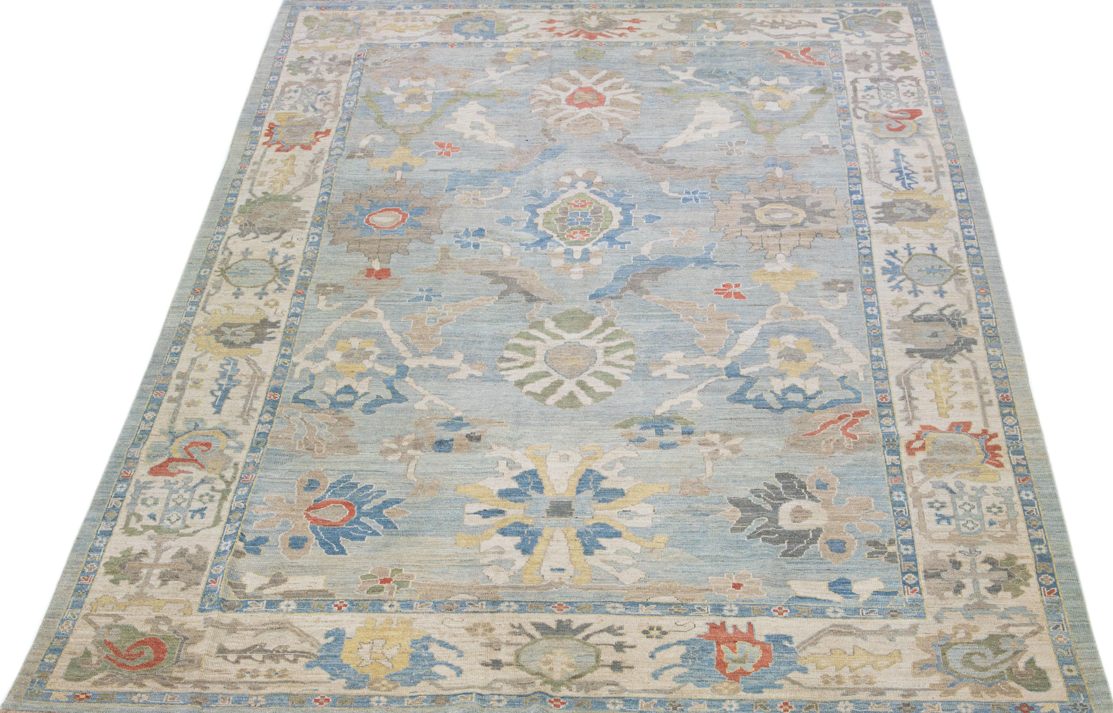 Beautiful modern Sultanabad hand knotted wool rug with a blue color field. This rug has a beige-designed frame with multicolor accents in a gorgeous all-over floral design.

This rug measures: 9'10