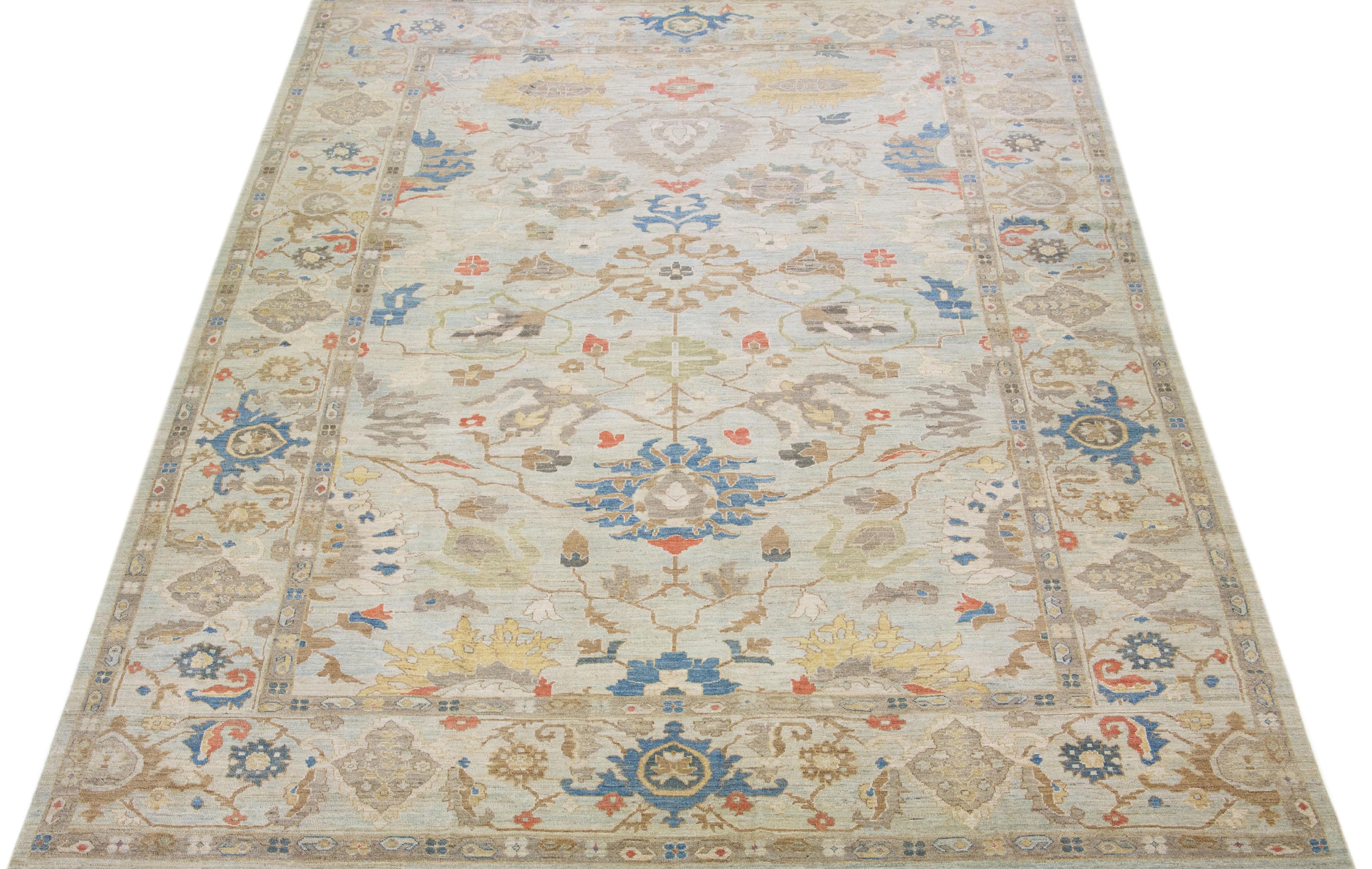 Beautiful modern Sultanabad hand knotted wool rug with a blue color field. This rug has a designed frame with rust, gray, and yellow accents in a gorgeous all-over floral design.

This rug measures: 8'10