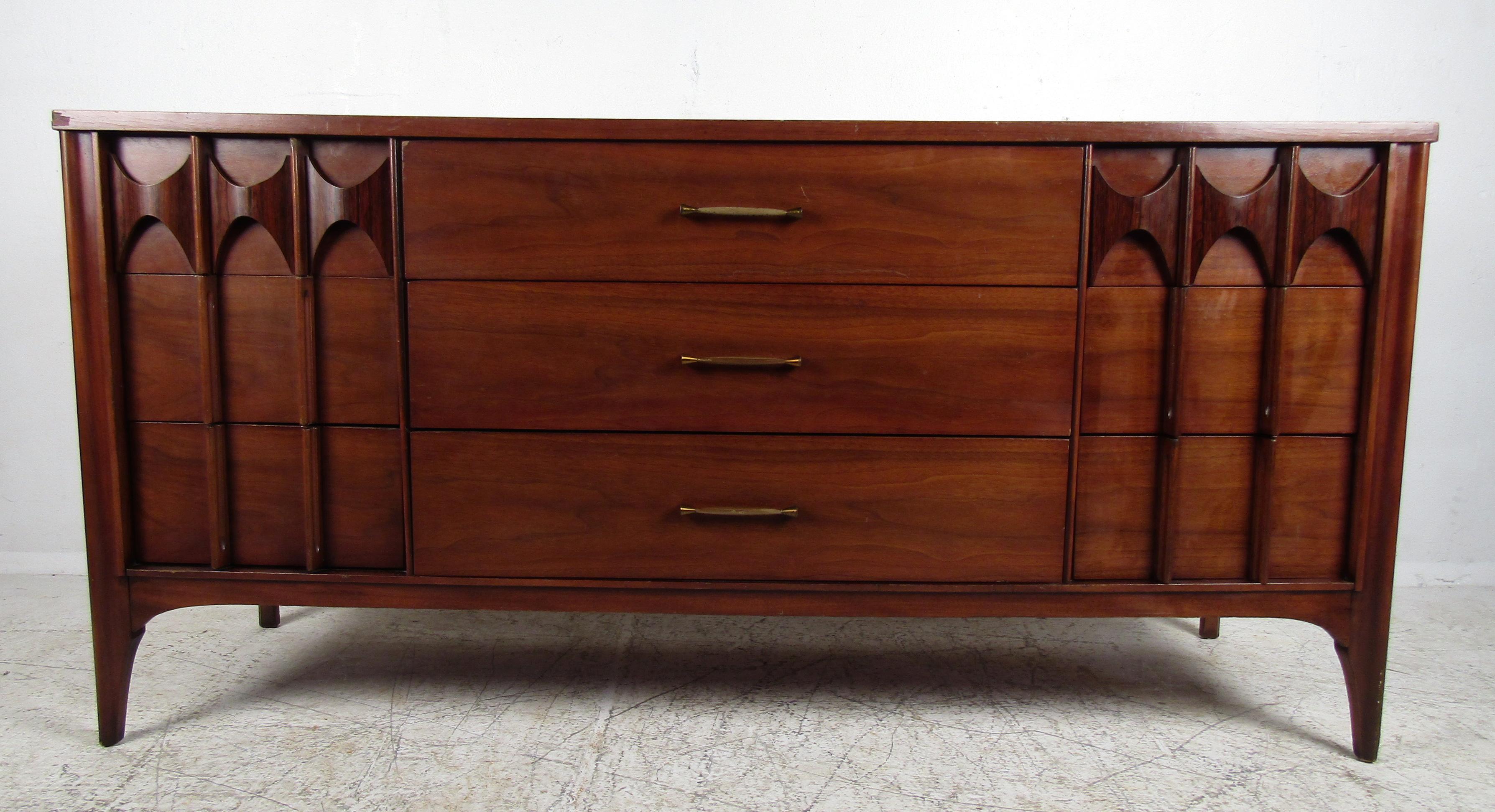 Mid-Century Modern server features nine drawers with wood sculpted pulls on a set of sturdy legs by Kent Coffey.

Please confirm the item location (NY or NJ).
     