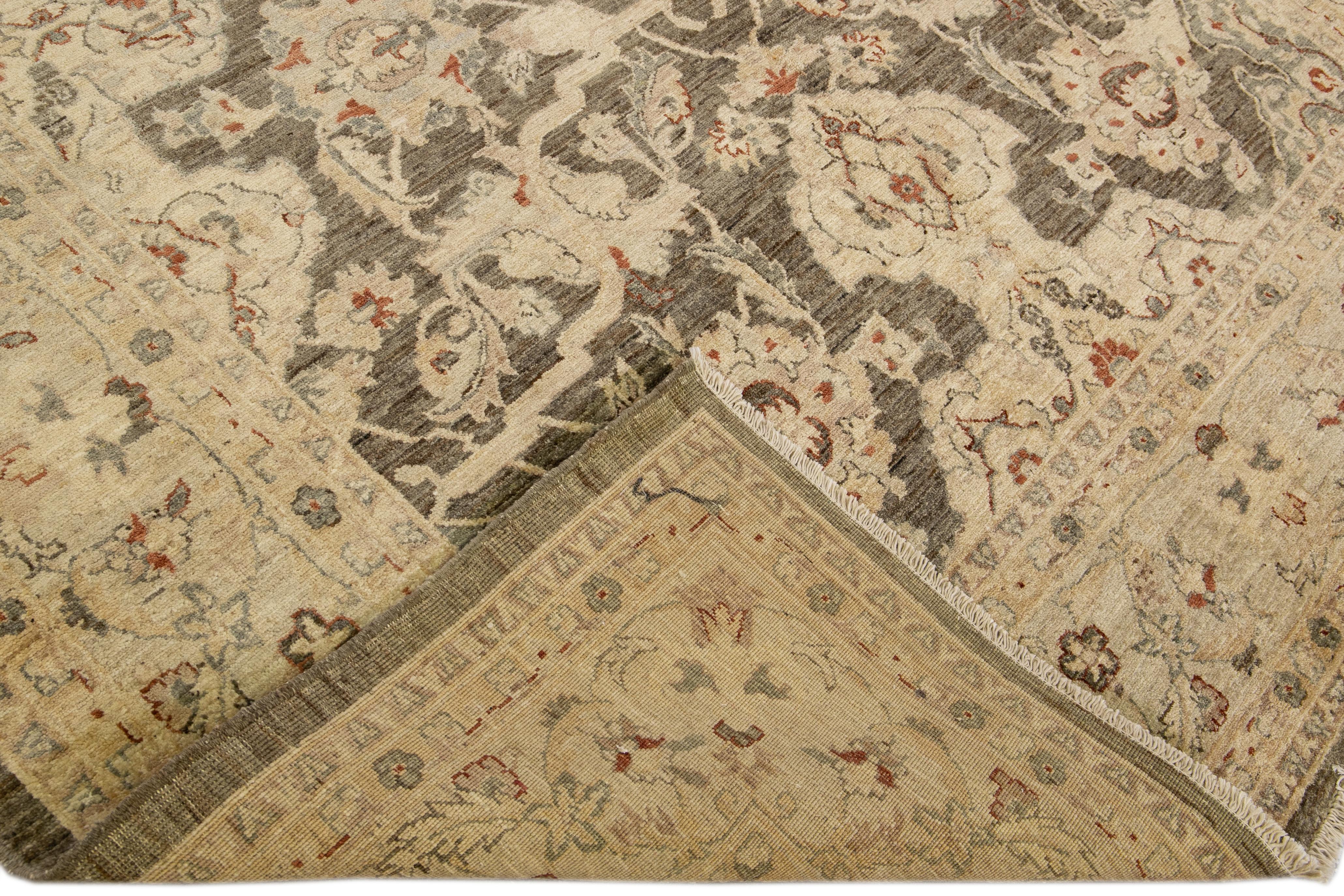 Beautiful oversize Paki Peshawar hand-knotted wool rug with a beige field. This modern rug has gray and tan accents in a gorgeous all-over Classic vine scroll and a palmettes motif.

This rug measures: 8' x 9'8