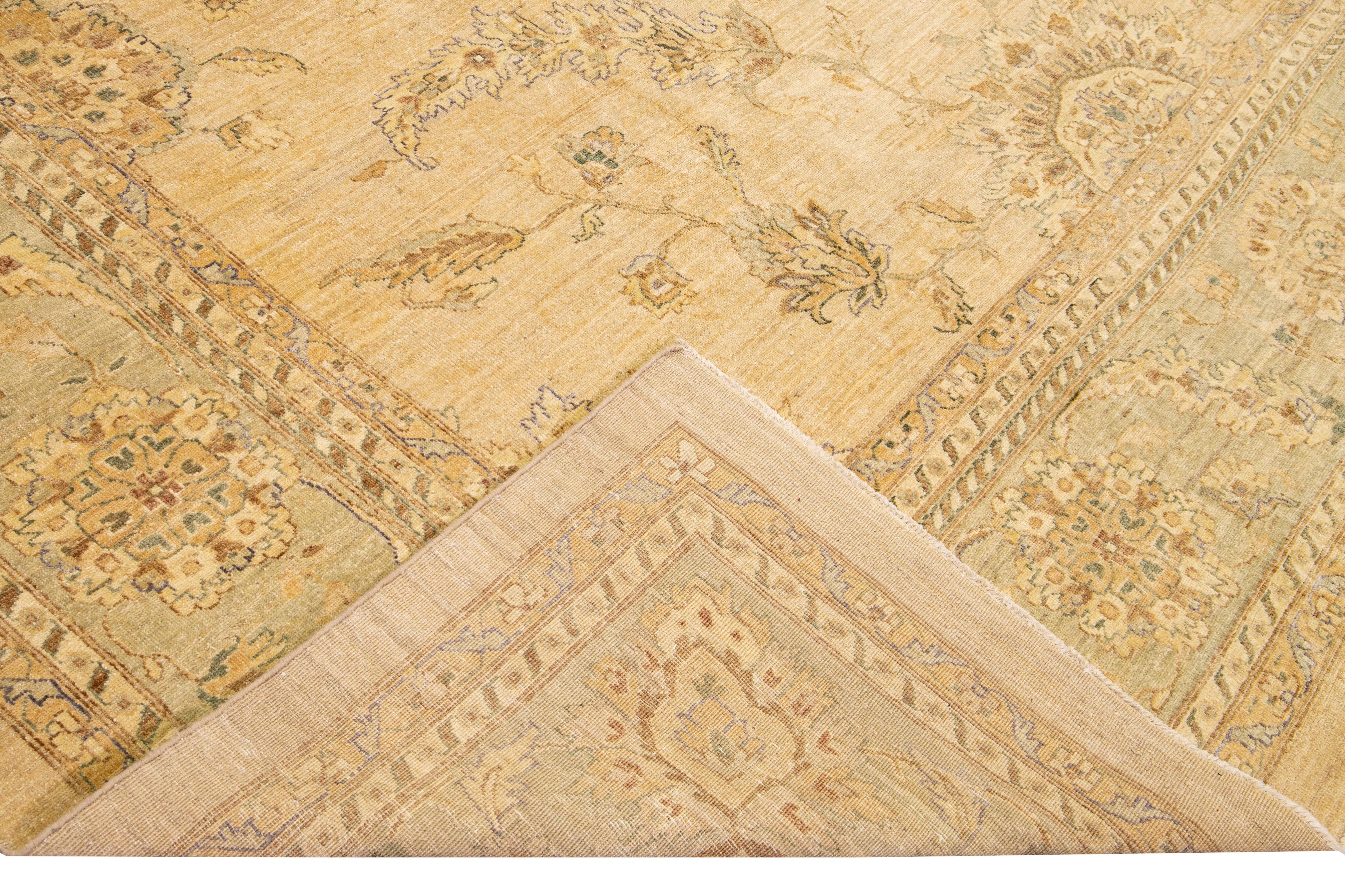 Beautiful Paki Peshawar hand-knotted wool rug with a beige field. This modern rug has tan and blue accents in a gorgeous all-over Classic vine scroll and a palmettes motif.

This rug measures: 11'8