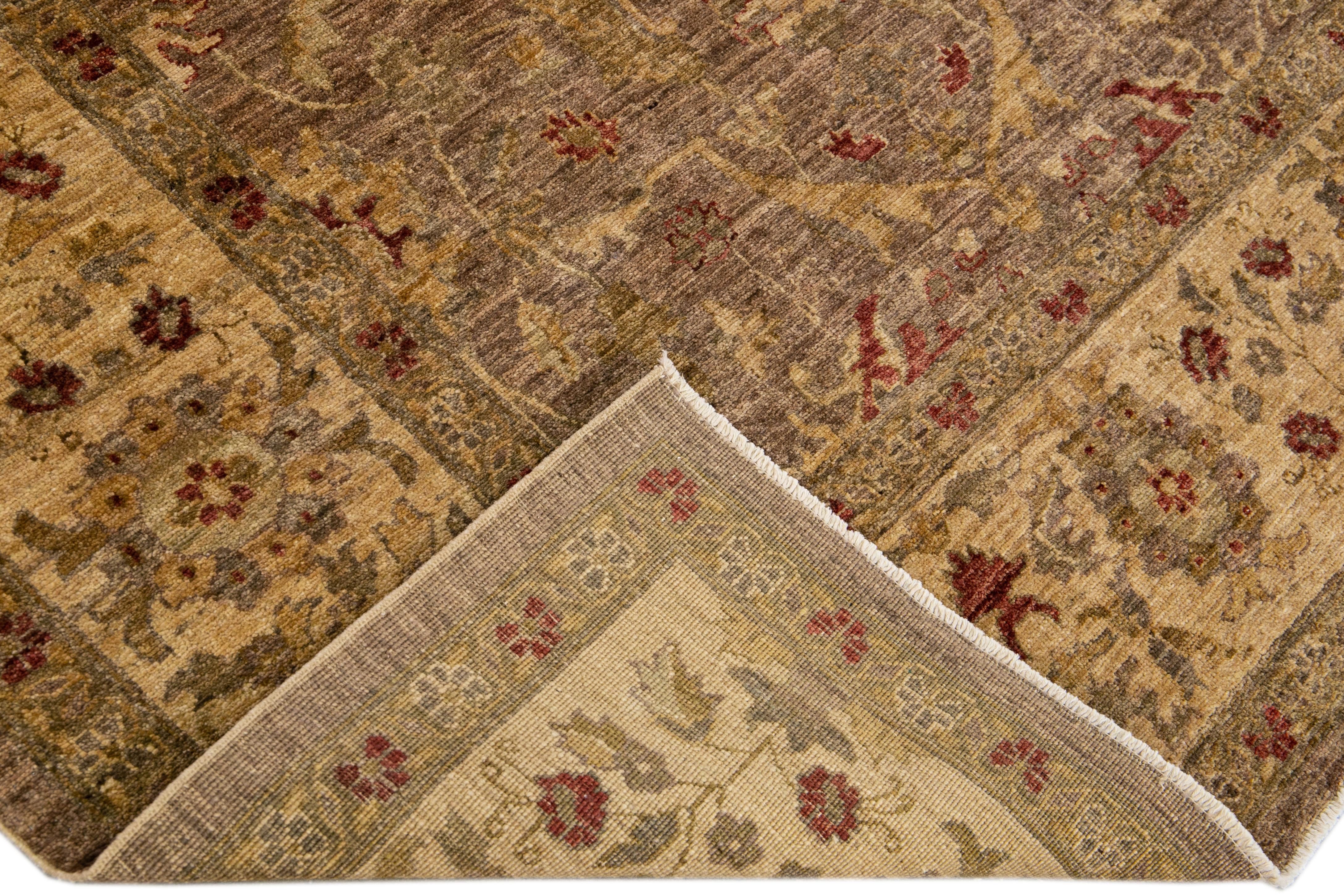 Beautiful oversize Paki Peshawar hand-knotted wool rug with a brown field. This modern rug has gray, beige, and red accents in a gorgeous all-over Classic vine scroll and a palmettes motif.

This rug measures: 8'4
