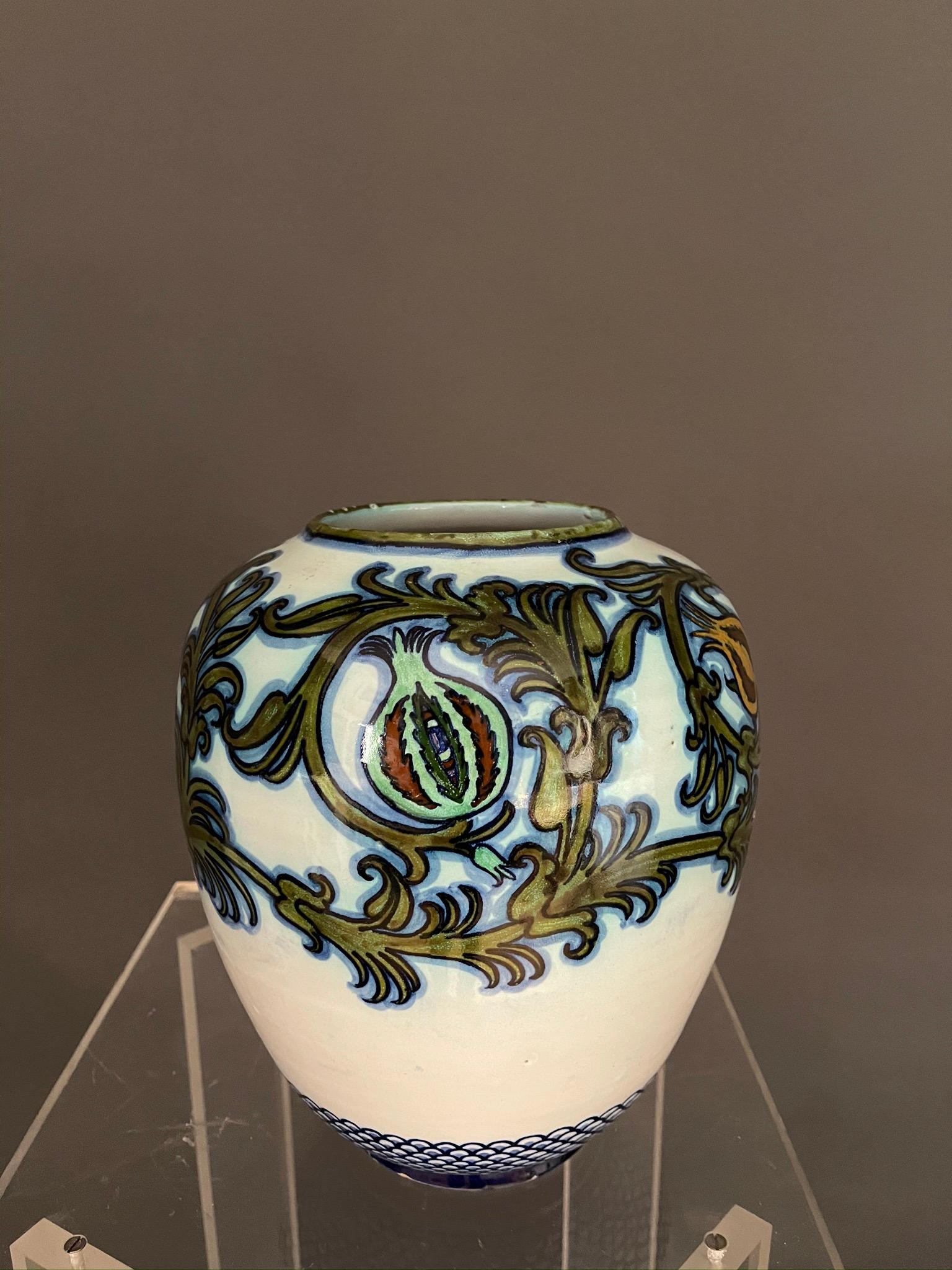 Italian artists Pietro Melandri and Paolo Zoli glazed majolica round shaped vase for ’La Faiance’. 
Faenza Italy 1915 ca.
This wonderful little masterpiece, depicting floral in shades of green to blue figures. 
Signed on underside.
Painter,