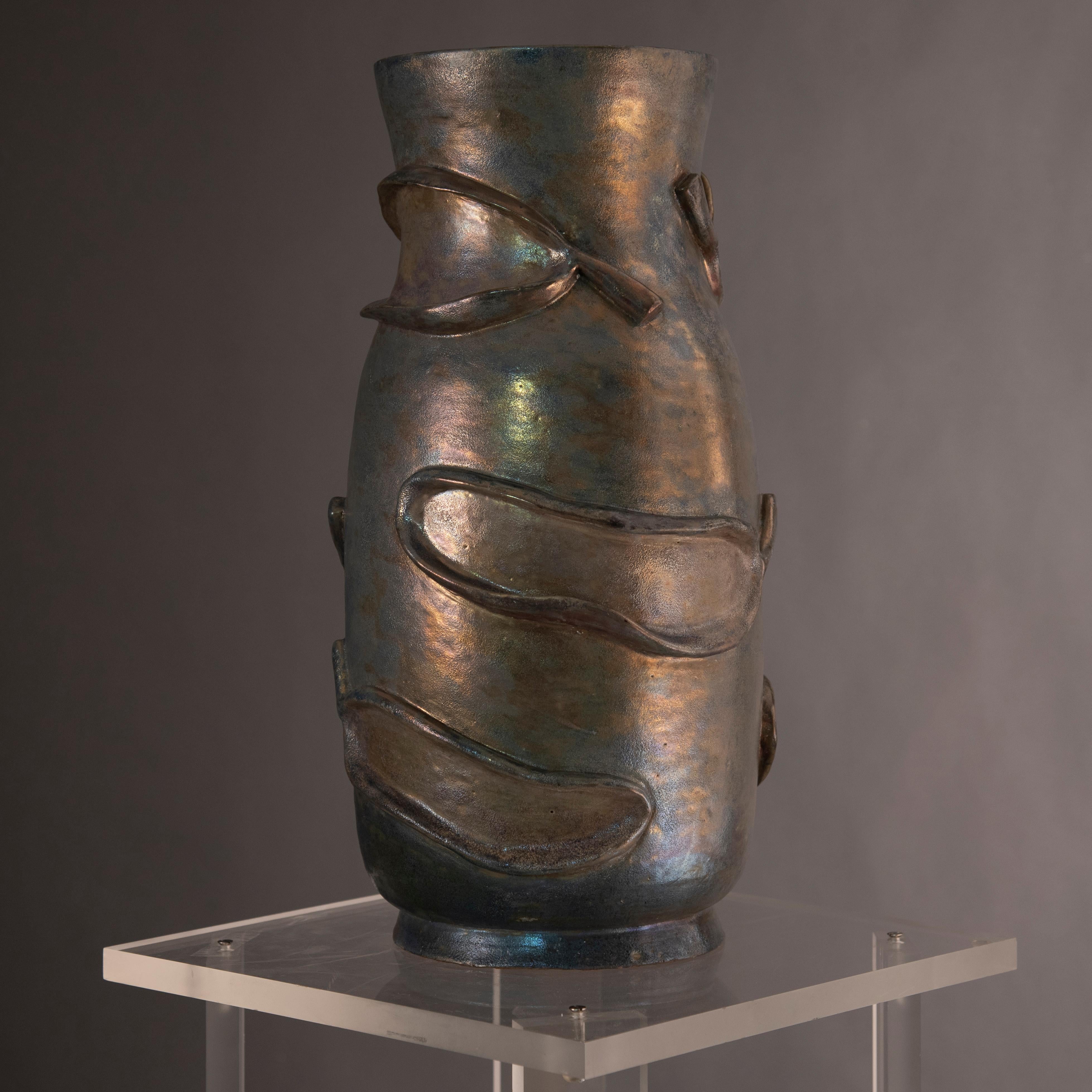 Pietro Melandri terracotta vase.
Faenza, 1938.
Tall vase made of grey-green majolica terracotta with golden metallic highlights. Signature at the base: Melandri.
He was one of the best Italian ceramist but also a scenographer and painter. 
He