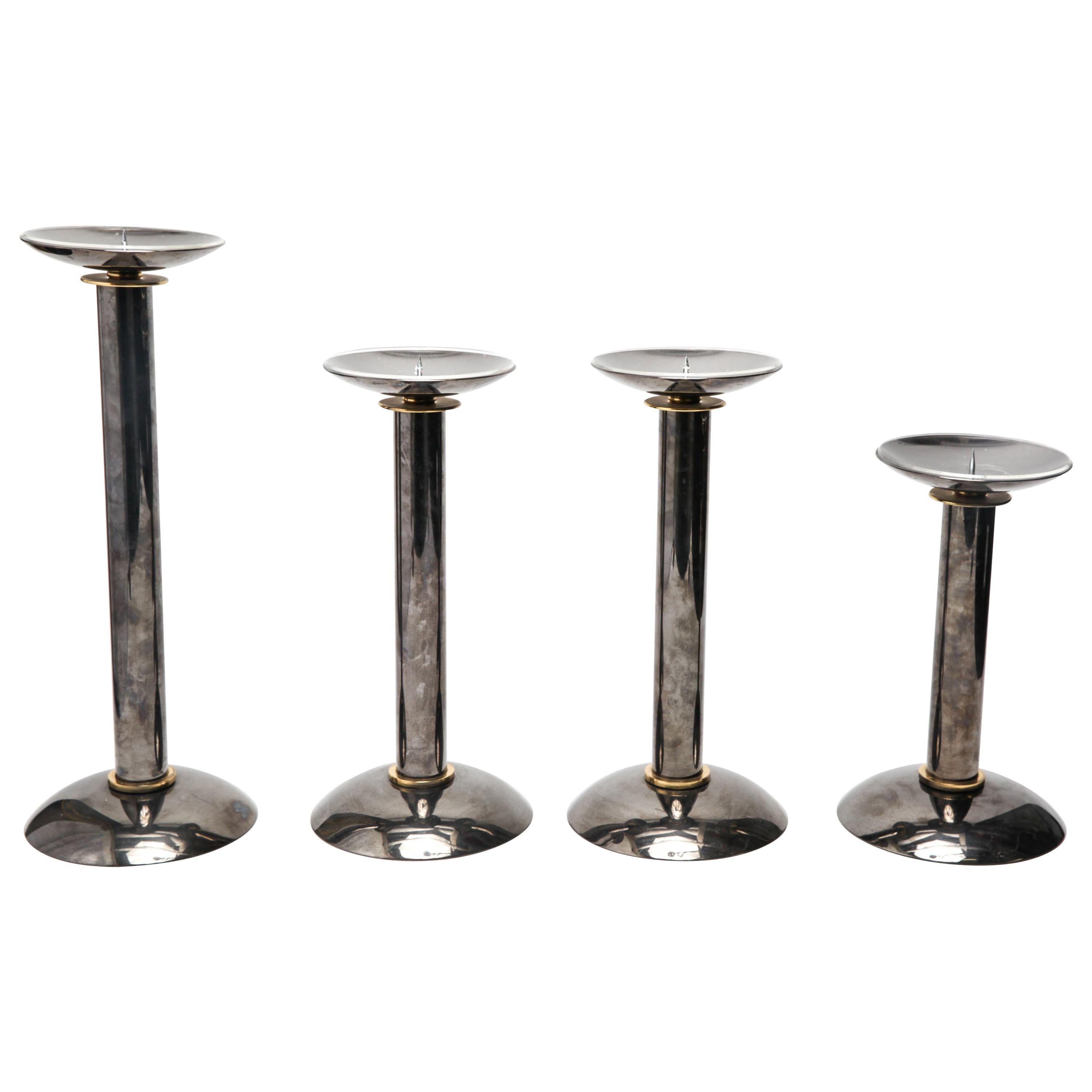 Modern metal pillar or pricket candlesticks / candleholders, with pewter tone body and brass accents. The set is on round bases. 2 pieces in different sizes. In great vintage condition with age-appropriate wear and use.
Measures: Largest 20