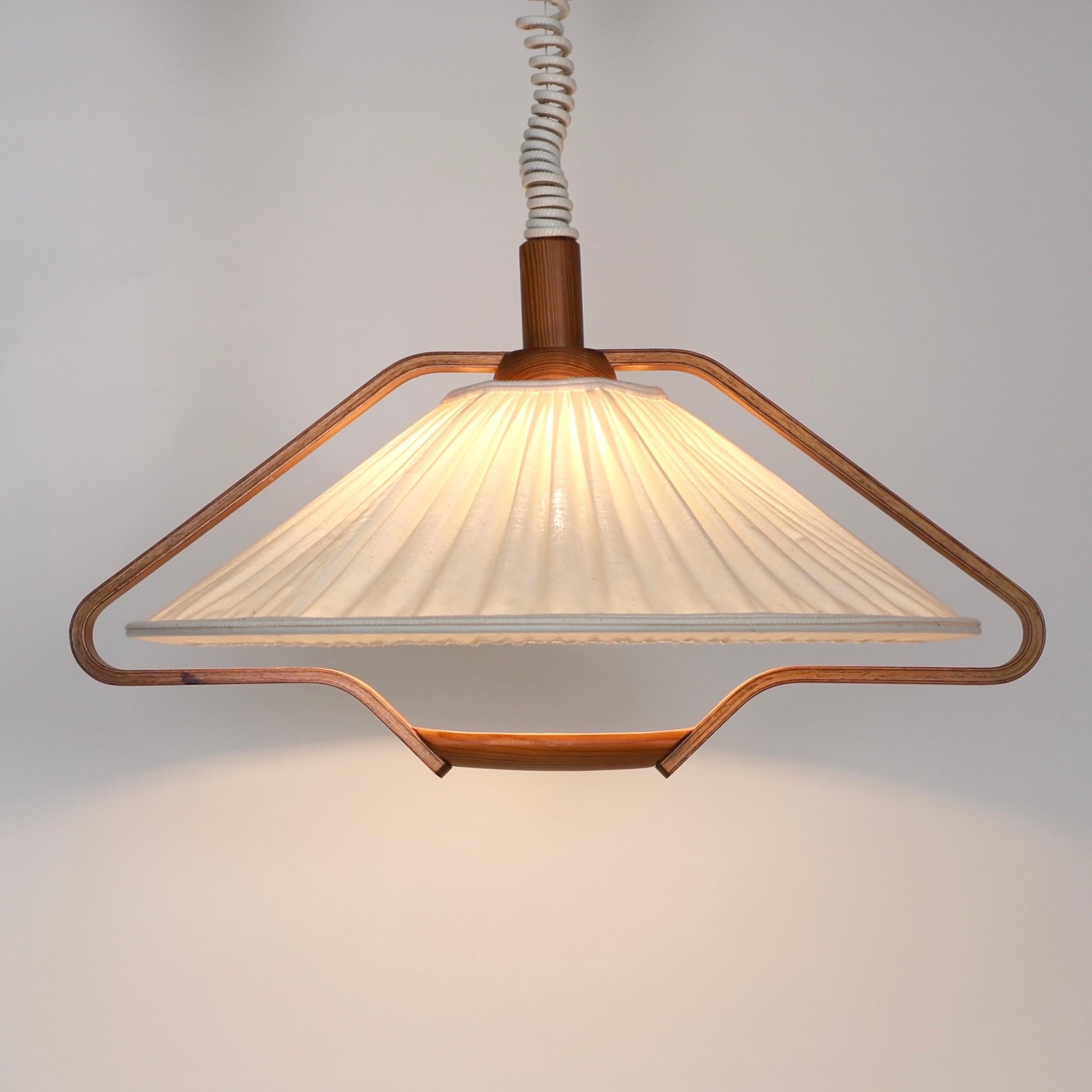 Modern Pine Wood Pendant Light by Markslöjd Sweden circa 1980s. A Scandinavian touch to a beautiful home.

* Pine wood veneer suspension pendant light with an off-white fabric shade.
* Manufacturer: Markslöjd, Sweden
* Year: circa 1980s
* Condition: