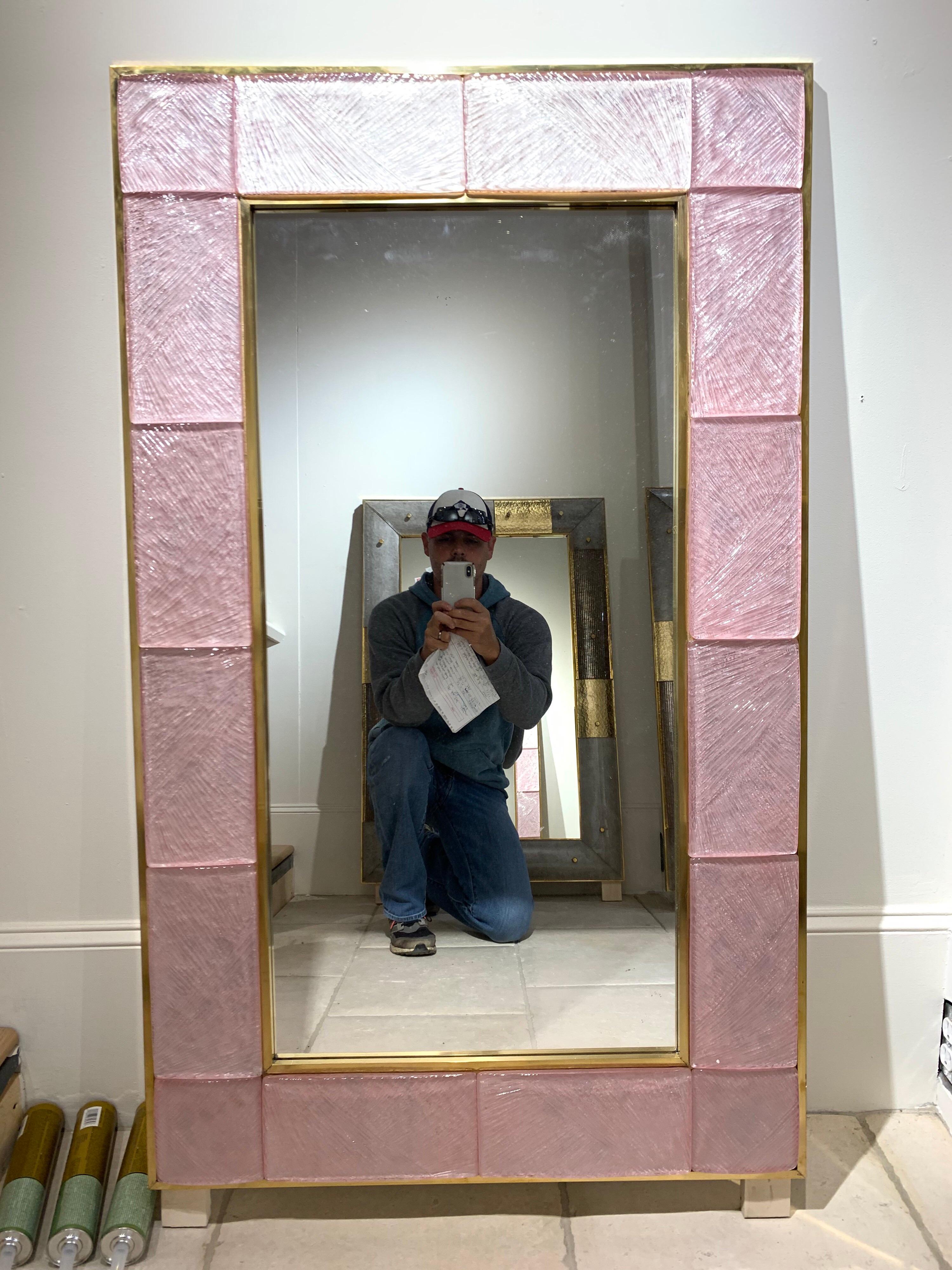 Fabulous modern pink Murano glass and brass mirrors. Gorgeous pink glass framed in brass. Creates a very decorative high end look! Note: Prices listed is for one. There are two available.