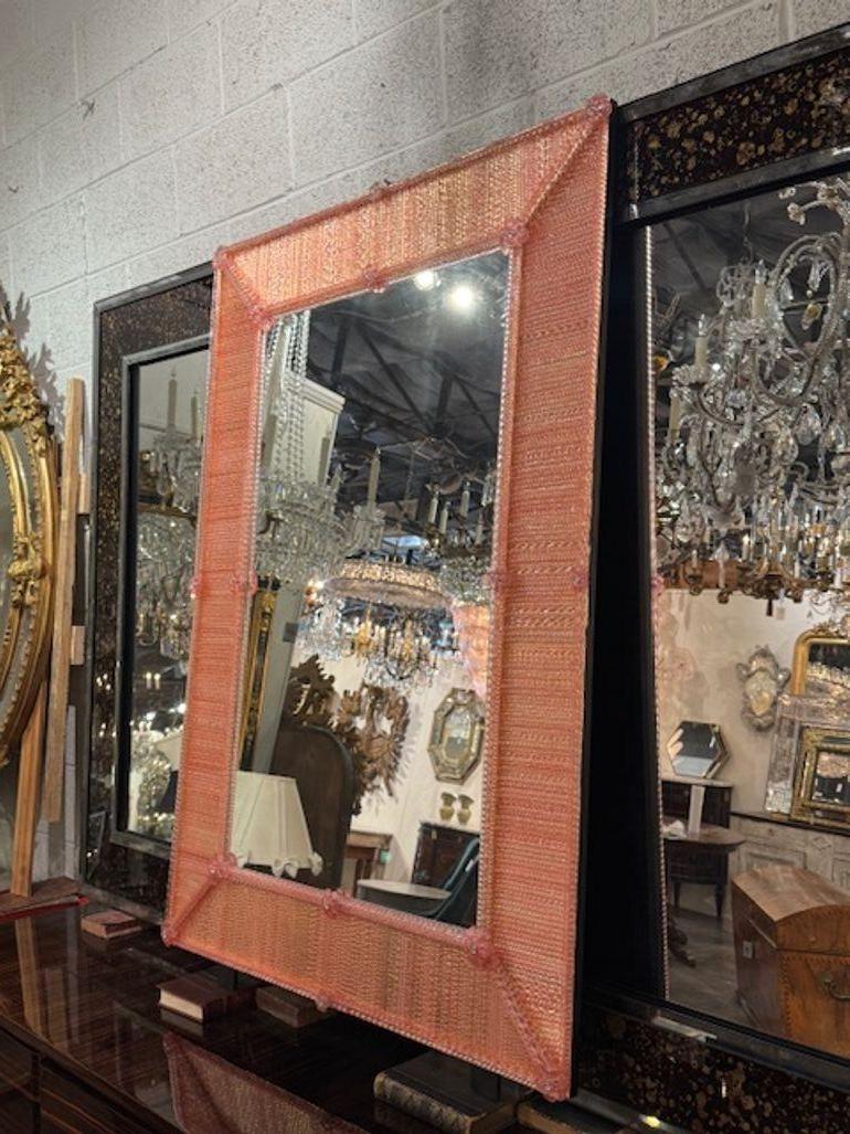 The Modern Pink Twist Murano Glass Mirror is a stylish and contemporary piece of home décor that adds a touch of elegance to any space. Crafted with high-quality Murano glass, this mirror features a unique pink hue that adds a playful yet