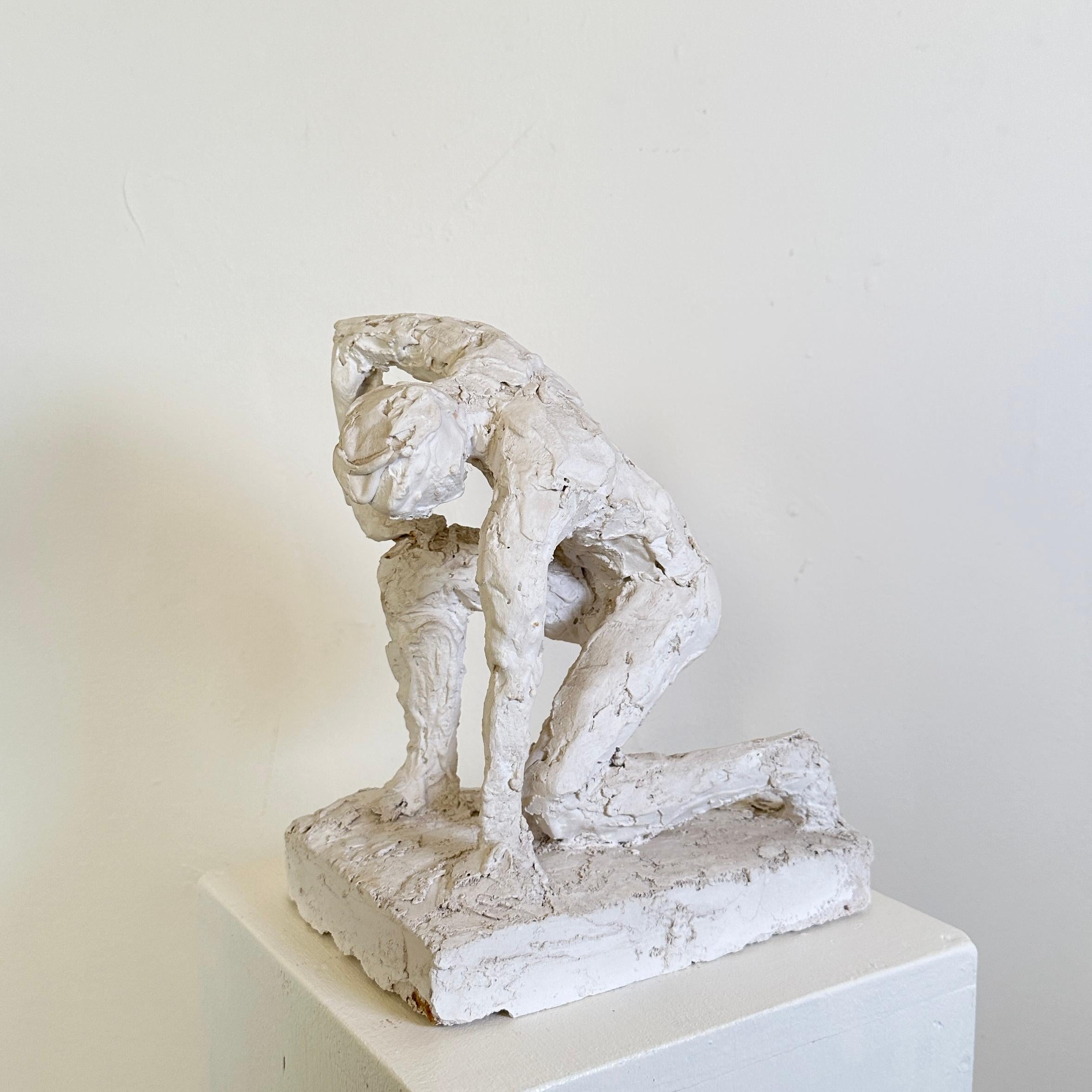 man kneeling to woman statue