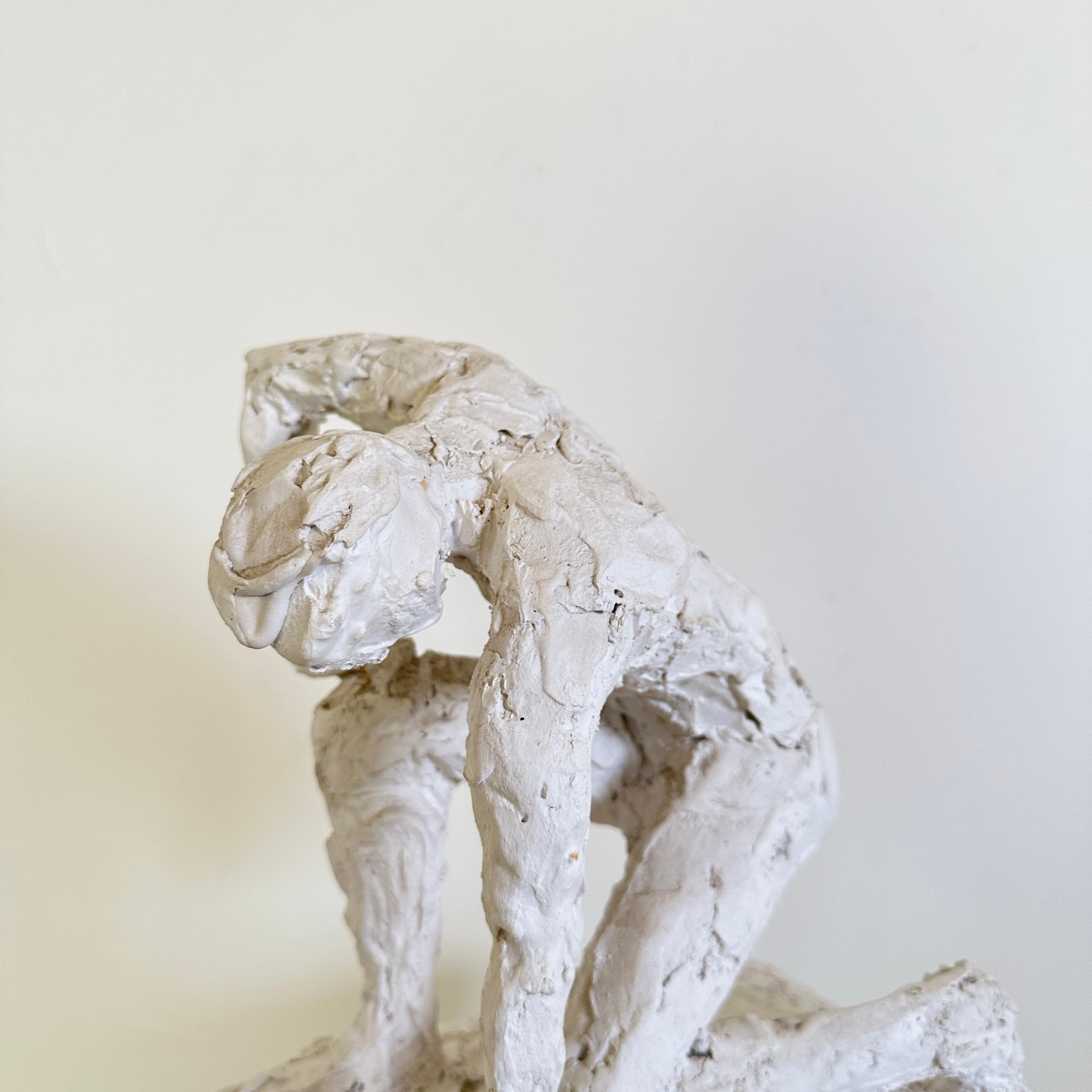 statue of man kneeling before woman