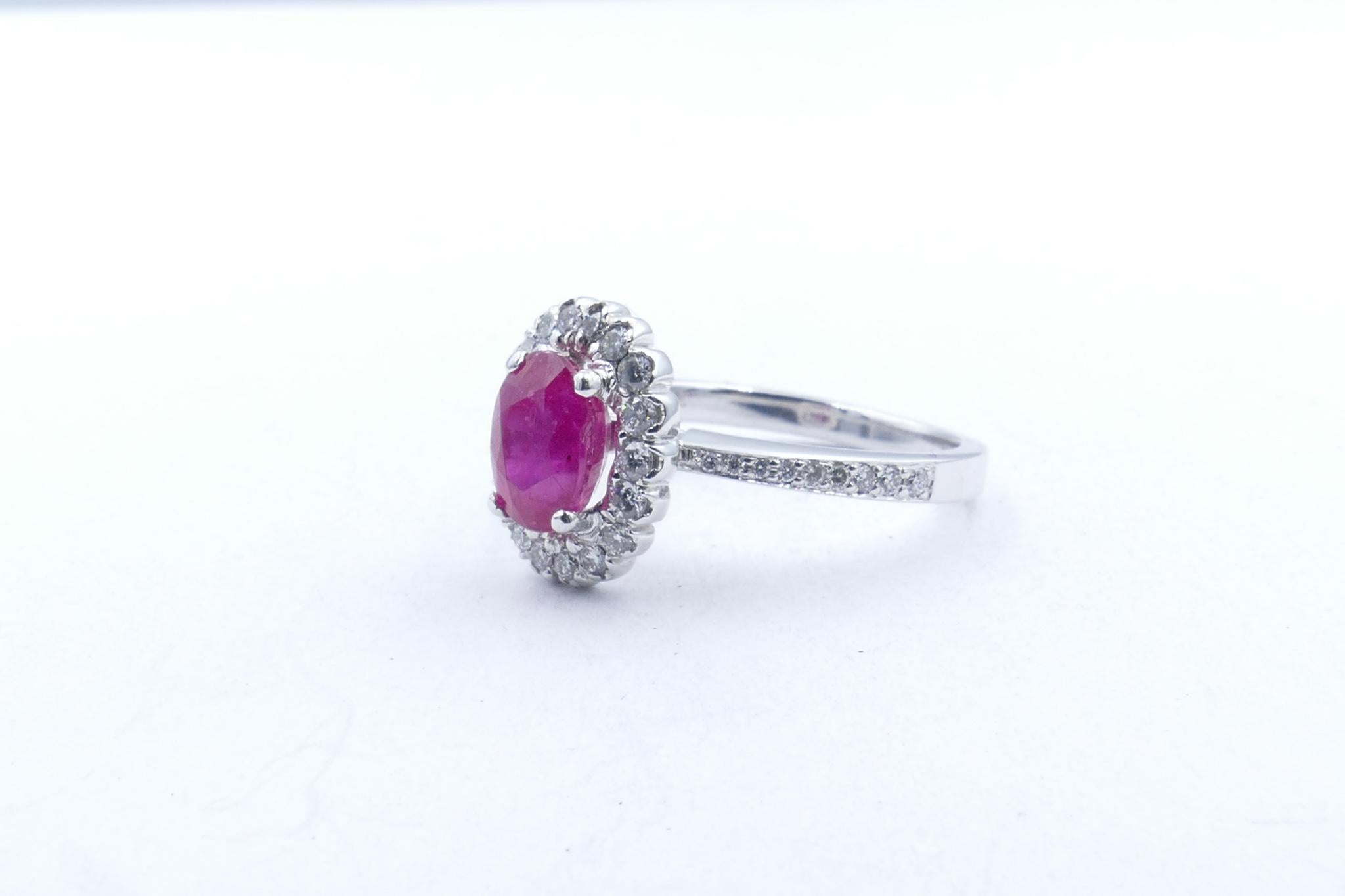 This gorgeous Ring features central oval cut Ruby 1ct in weight, of a beautiful deep red hue. 
It is surrounded by a half carat of good quality Diamonds G/H in colour and SI Clarity, which extend down the shank.
A Ring that sits beautifully on the