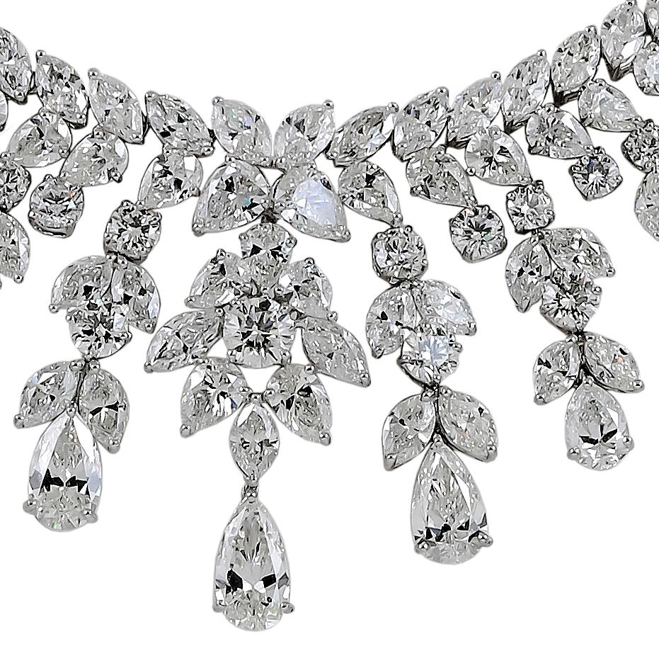 An exquisite diamond necklace, designed as a series of graduated trefoil pear-shaped diamond links of a foliate motif, alternating with luminous brilliant-cut diamonds, the front set with a fringe of pear-shaped diamonds, finely mounted in