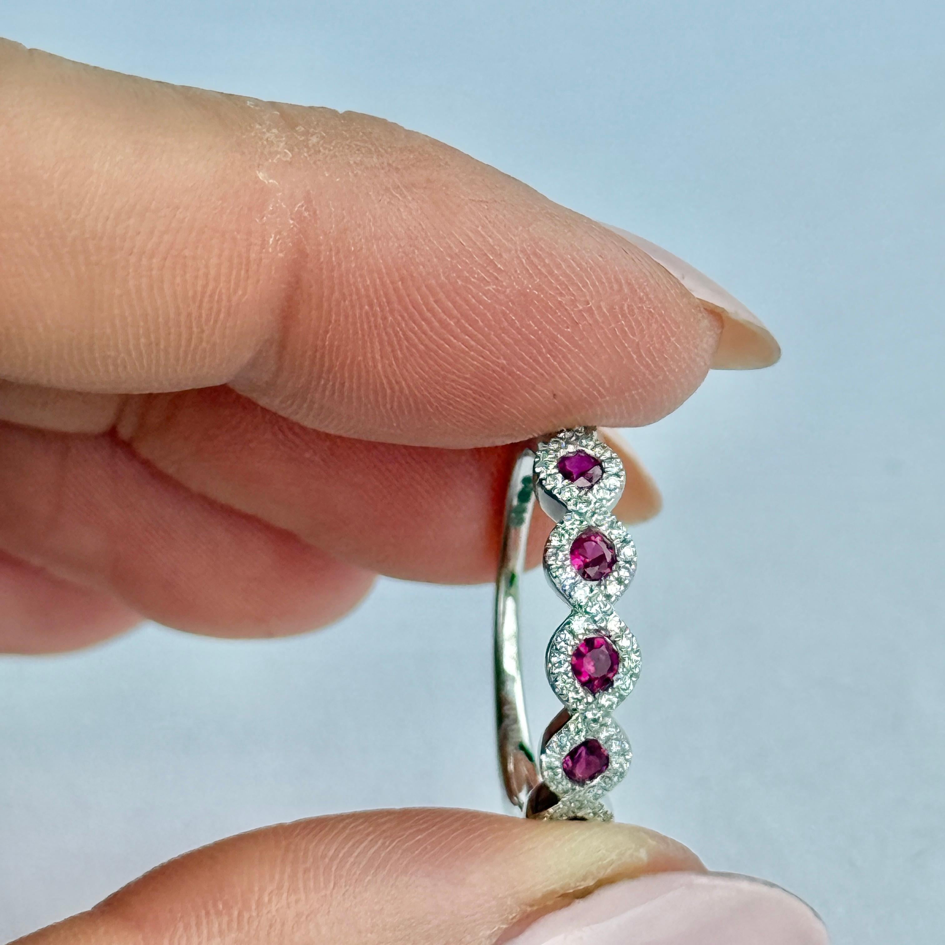 This gorgeous ring is so sparkly. The ring is modelled in platinum and is set with five pink rubies. Surrounding the rubies are diamonds. The rubies measure 5pts each and each diamond halo totals 10pts. 

Ring Size:  M or 6 1/4
Face Width: