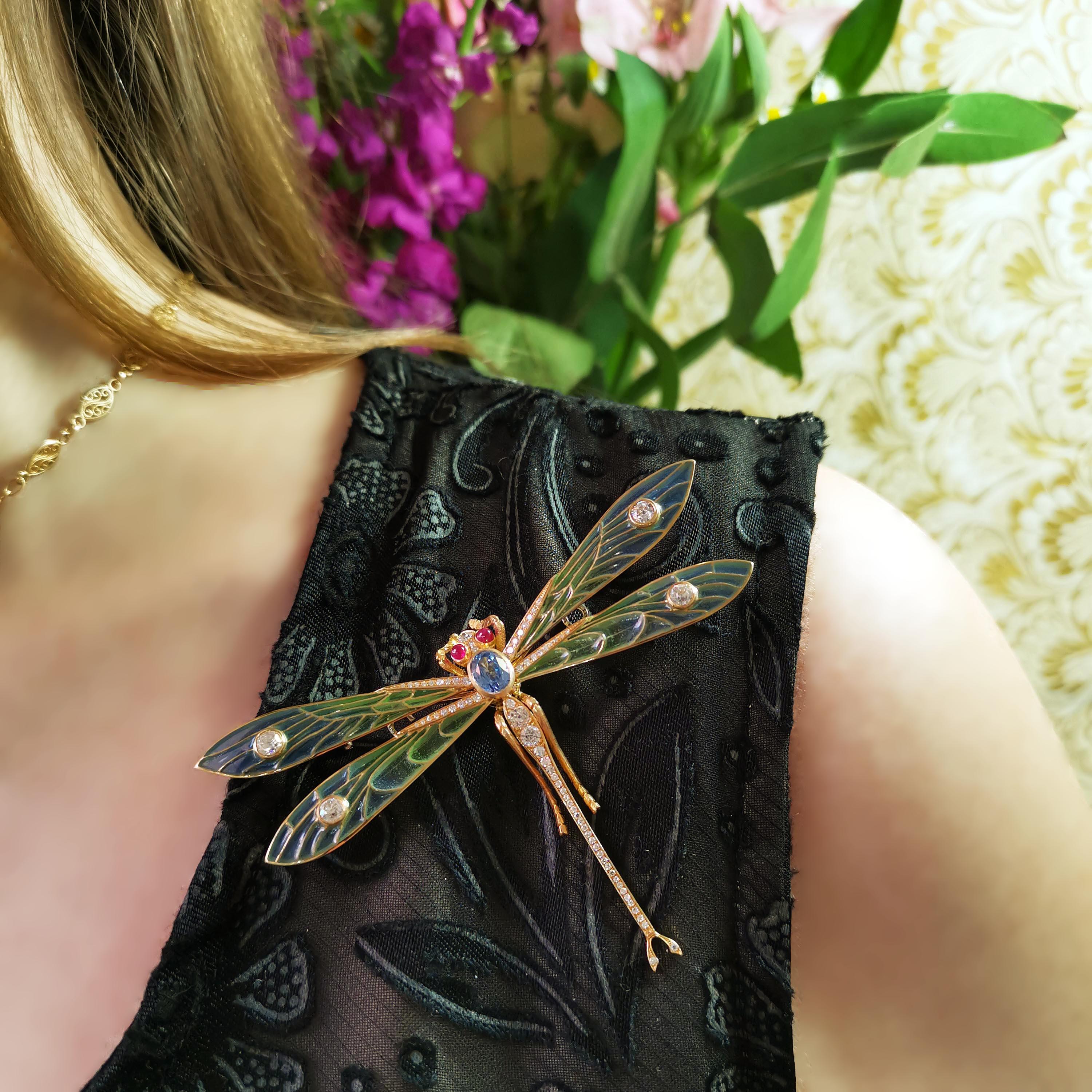 A modern gem set dragonfly brooch, with trembling wings, with an oval faceted sapphire, weighing  1.73 carats, set in the thorax, with blue to green plique à jour enamel wings, with an old-cut  diamond in each wing tip and two in the tail, with