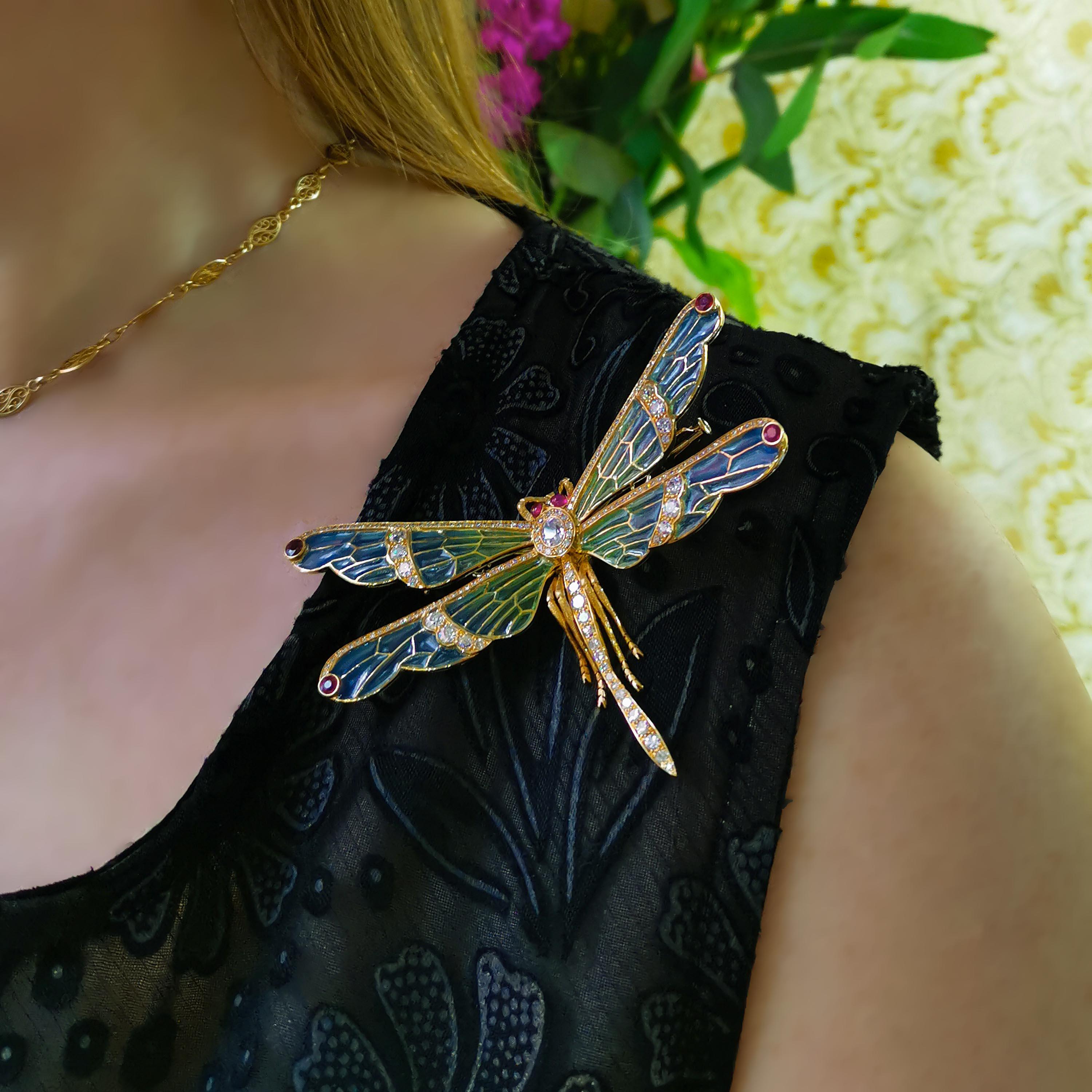 A gem set dragonfly brooch, with an oval shaped, old-cut diamond, weighing 0.37 carats, set in the thorax, with surrounding eight-cut diamonds, with blue to green plique à jour enamel wings, with old-cut diamonds in the centre of the wings, with