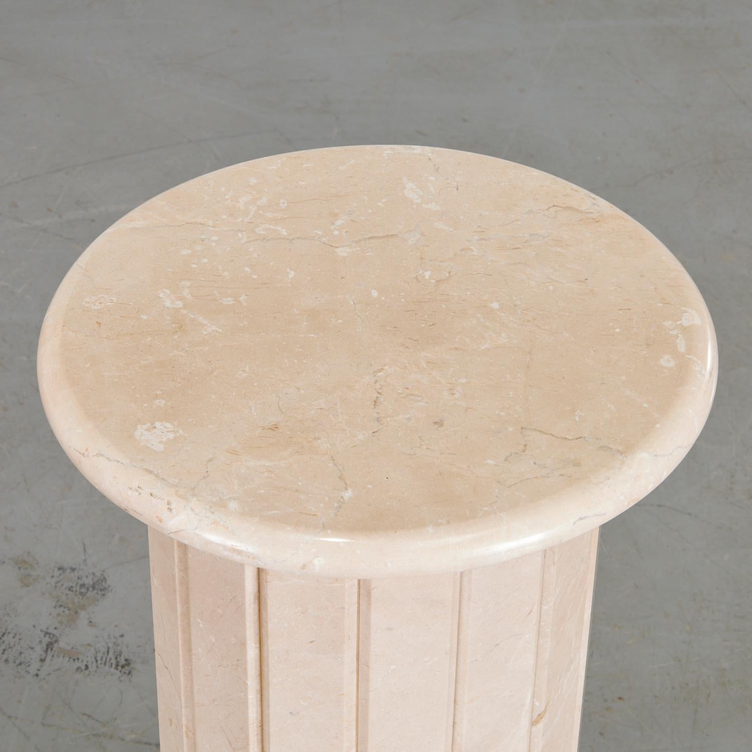A modern Travertine fluted column pedestal. The pedestal has been polished to allow the wonderful soft pale earth tones to shine. This is a very smart looking pedestal that could serve many purposes.This pedestal could be used as an end table, for