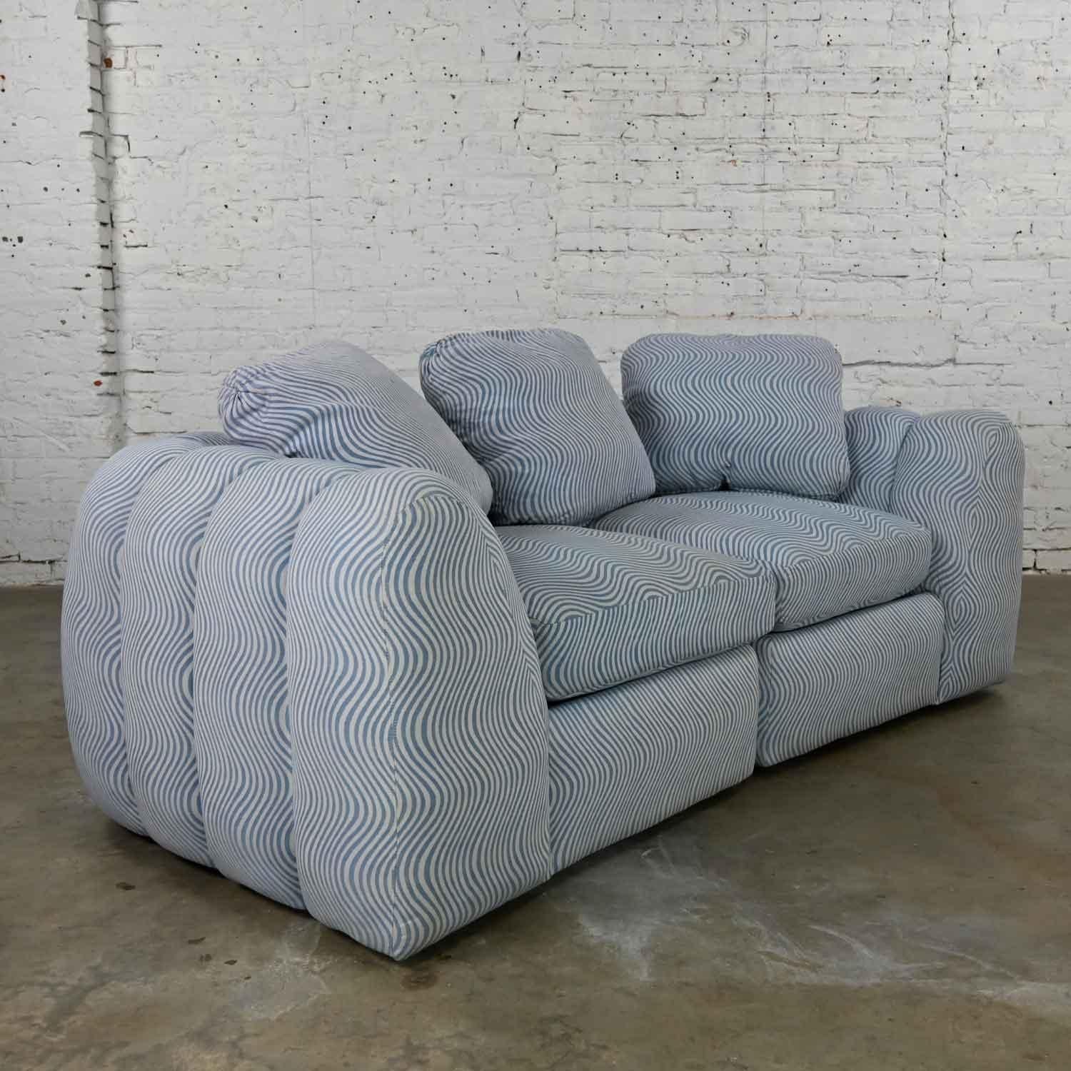 Wonderful modern to postmodern channeled sectional loveseat or lounge chairs in the style of Jay Spectre. Comprised of foam seats, feather down back pillows, upholstered in blue & white fabric. Beautiful condition, keeping in mind that this is