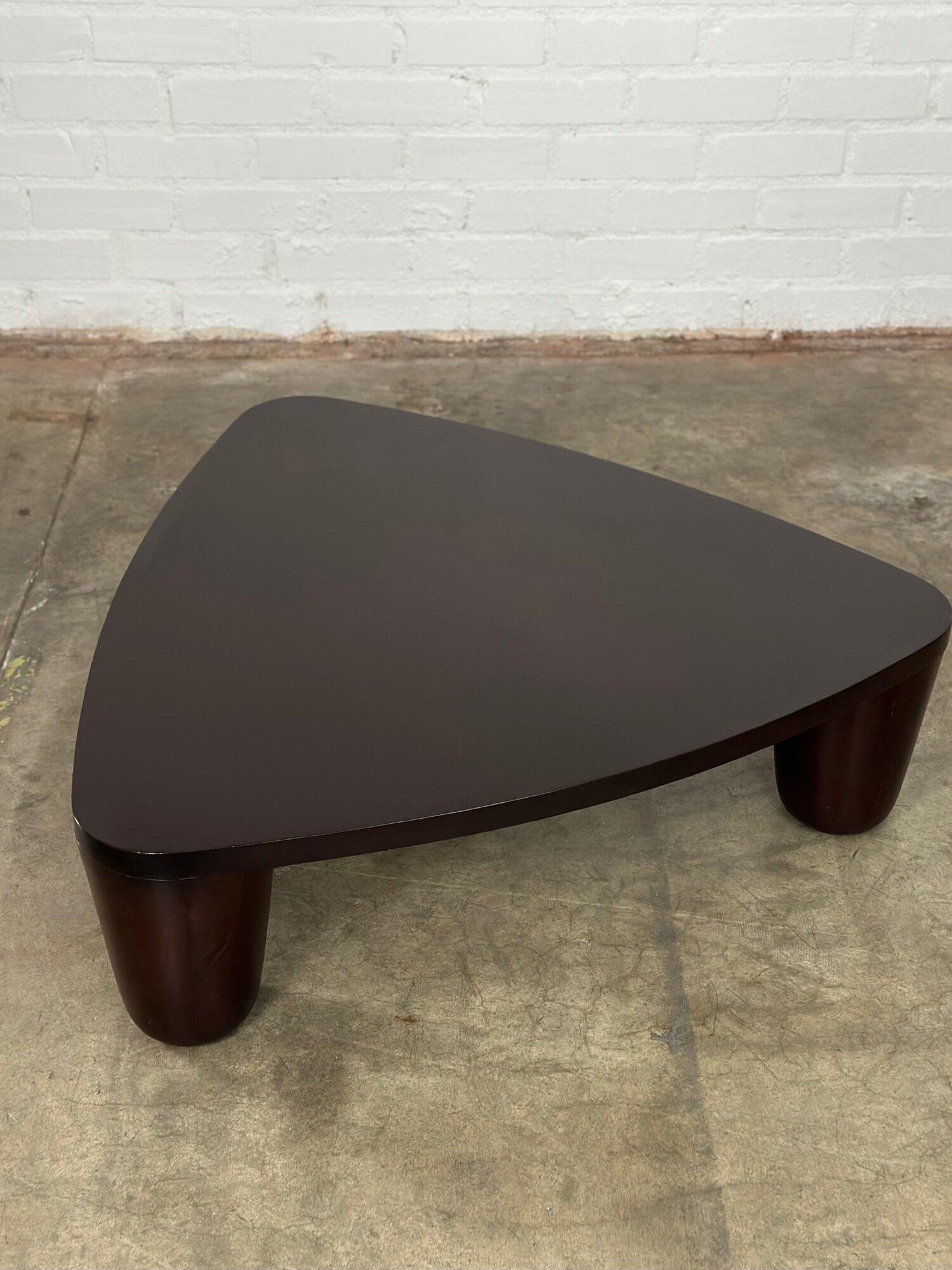 Measures : W41 D40 H12

This coffee table has a unique Primitive esthetic in a modern chic construction with a deep espresso finish. The legs are a chunky cone at each point of the triangle adding to the Primitive style. Over all in good restored